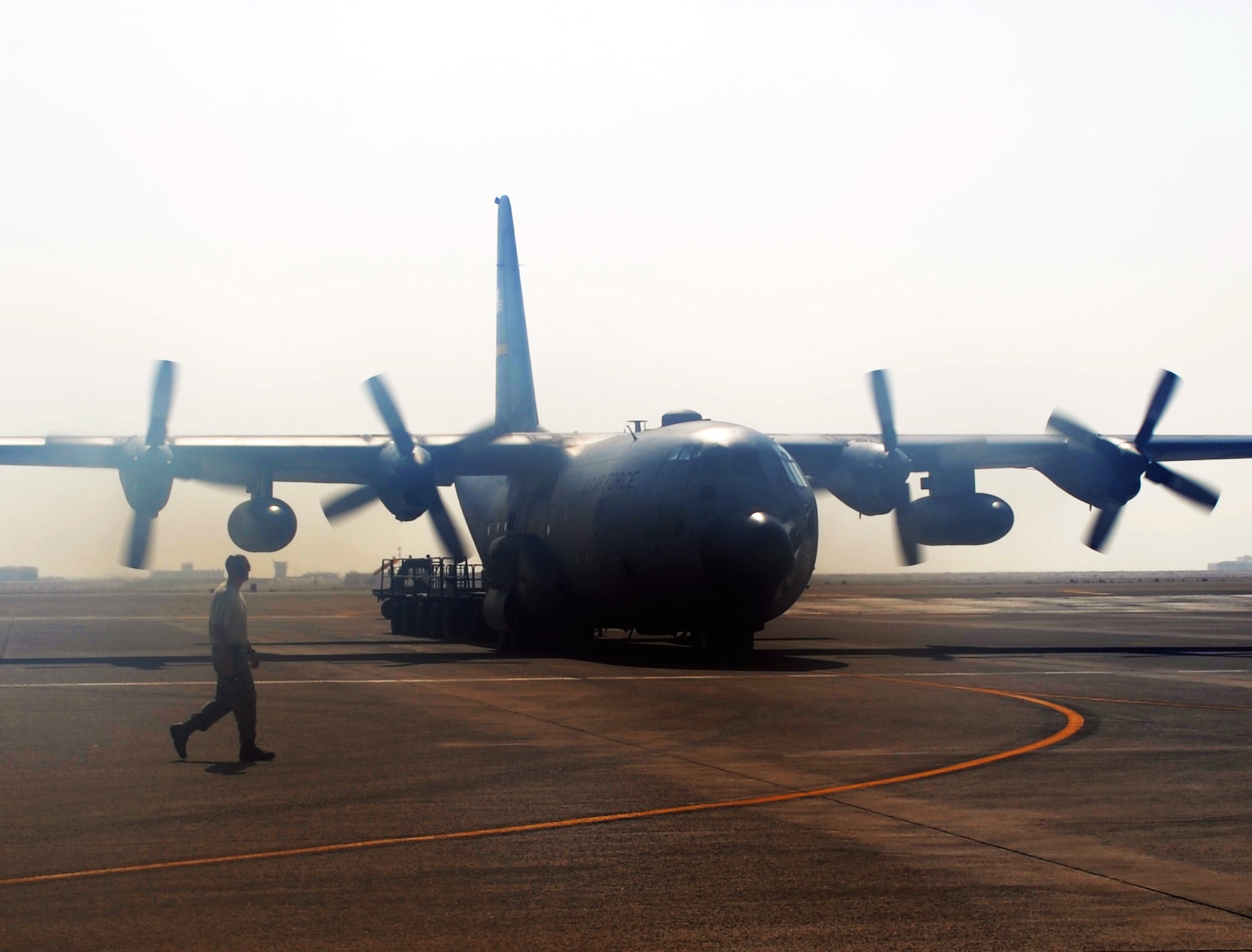 An Air Force Reserve C-130 Hercules and its crew, along with aerial port Airmen and maintenance Airmen, perform an "engines running off-load" at a non-disclosed base in Southwest Asia on Feb. 16, 2010.  The C-130, deployed from the 911th Airlift Wing at Pittsburgh, Penn., is one of the main airlift airplanes used in the U.S. Central Command area of responsibility moving tons of cargo and thousands of people every day. (U.S. Air Force Photo/Master Sgt. Scott T. Sturkol/Released) 