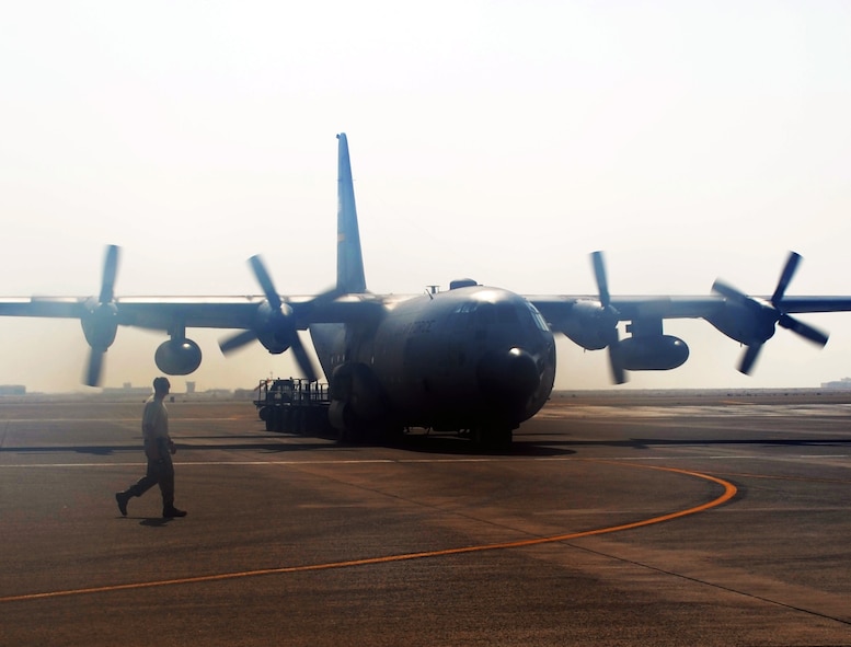 An Air Force Reserve C-130 Hercules and its crew, along with aerial port Airmen and maintenance Airmen, perform an "engines running off-load" at a non-disclosed base in Southwest Asia on Feb. 16, 2010. The C-130, deployed from the 911th Airlift Wing at Pittsburgh, Penn., is one of the main airlift airplanes used in the U.S. Central Command area of responsibility moving tons of cargo and thousands of people every day. (U.S. Air Force Photo/Master Sgt. Scott T. Sturkol)