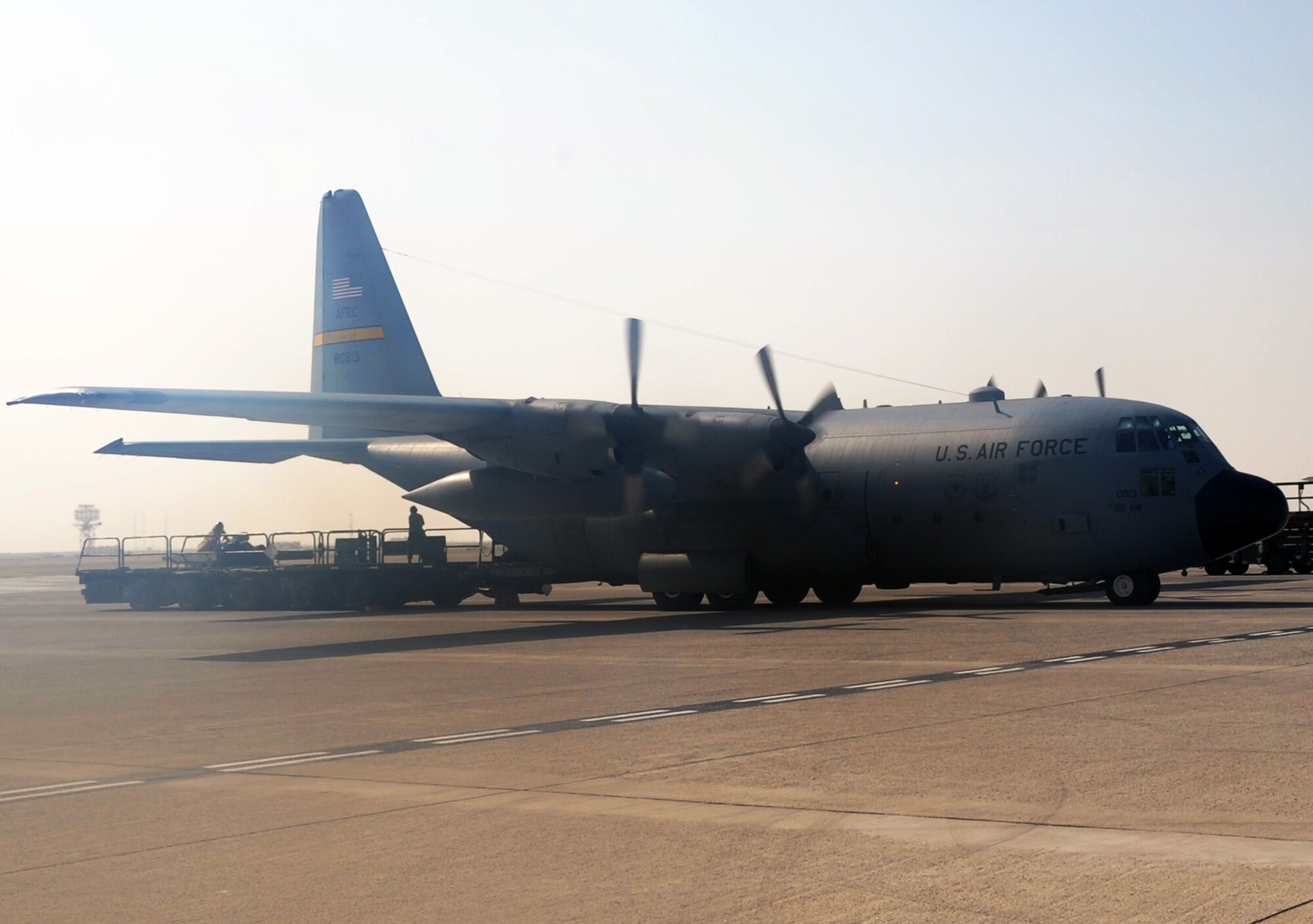 An Air Force Reserve C-130 Hercules and its crew, along with aerial port Airmen and maintenance Airmen, perform an "engines running off-load" at a non-disclosed base in Southwest Asia on Feb. 16, 2010.  The C-130, deployed from the Pennsylvania Air National Guard's 911th Airlift Wing at Pittsburgh, is one of the main airlift airplanes ised in the U.S. Central Command area of responsibility moving tons of cargo and thousands of people every day. (U.S. Air Force Photo/Master Sgt. Scott T. Sturkol/Released) 