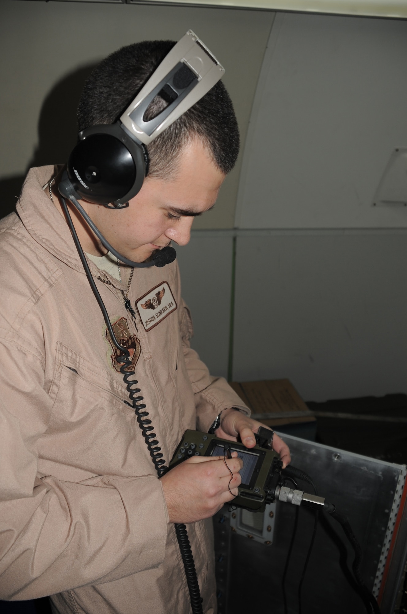 Senior Airman Joshua Slinkard, an E-3 Sentry aircrew member, does a systems check on an E-3 while the plane is in flight for a mission Feb. 16, 2010. Airman Slinkard and the E-3 he's flying on is deployed to a non-disclosed base in Southwest Asia with the 965th Expeditionary Airborne Air Control Squadron. (U.S. Air Force Photo/Master Sgt. Scott T. Sturkol)