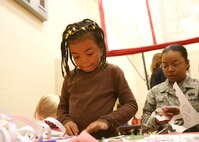 Staff Sgt. Kenya Appiah, 737th Training Support Squadron, and her daughter Kei'erah Greene, work on a craft during the African American Heritage Celebration at the youth center Feb. 19. The celebration included games, displays and activities showcasing African American culture. The event was part of a month-long celebration on Lackland honoring the accomplishments and contributions of African Americans to society. (U.S. Air Force photo/Robbin Cresswell)