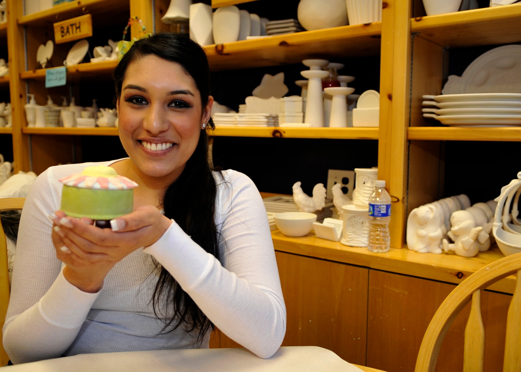 AURORA, Colo. -- Airman 1st Class Manisha Vasquez, 460th Space Wing, exhibits  her finished masterpiece at a local arts and crafts shop. Painting pottery can be a low-cost way to relax after a hard day. (U.S. Air Force photo by Airman 1st Class Paul Labbe)
