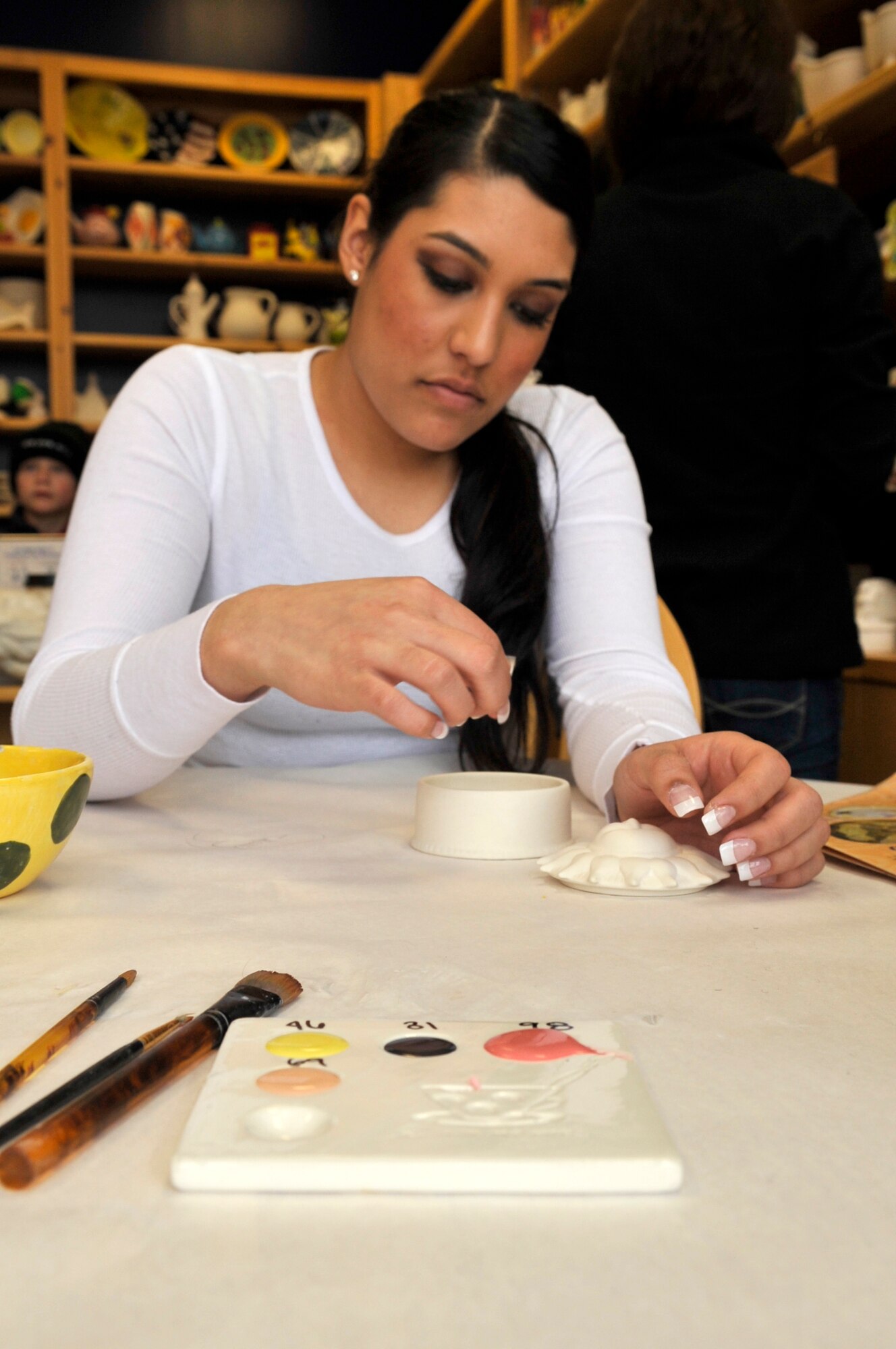 AURORA, Colo. -- Airman 1st Class Manisha Vasquez begins the process of cleaning out her pottery to paint at a local arts and crafts shop. (U.S. Air Force photo by Airman 1st Class Paul Labbe)
