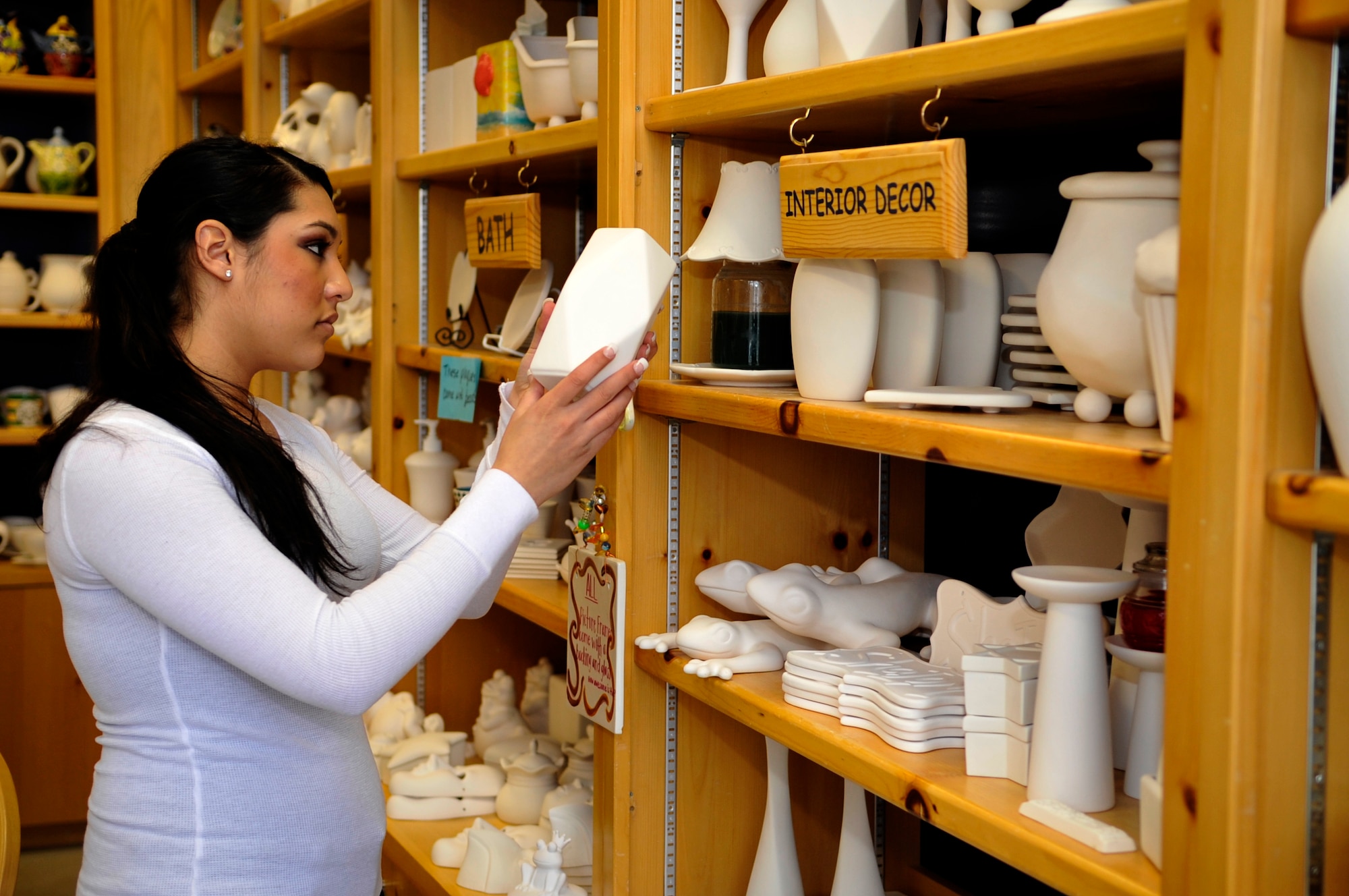 AURORA, Colo. -- Airman 1st Class Manisha Vasquez, 460th Space Wing, selects pottery to paint at a local arts and crafts shop. Exploring Aurora and the rest of the Denver Metropolitan Area is a great way for dormitory-bound Airmen to put some variety into their lives. (U.S. Air Force photo by Airman 1st Class Paul Labbe)
