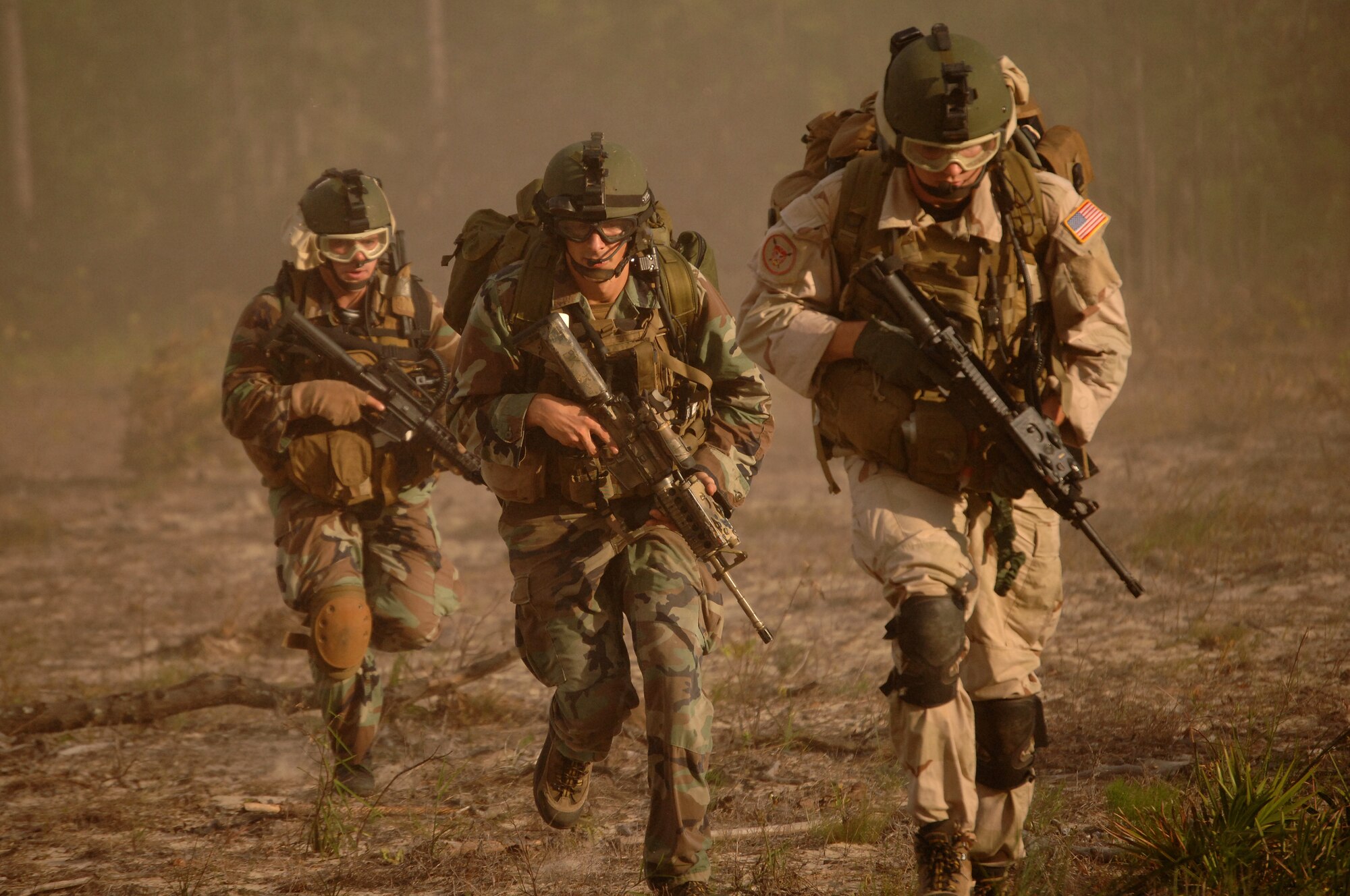 Combat control and pararescue trainees run to their rally point after off-loading a helicopter Sept. 7, 2007, at Hurlburt Field, Fla. The special tactics Airmen were conducting a combat search and rescue training scenario on base at Eglin Air Force Base, Fla. AST is the last phase of training for combat controllers before they report to operations special tactics squadrons. (U.S. Air Force photo/Senior Airman Ali Flisek)