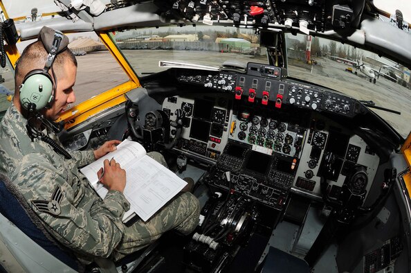 U.S Air Force Senior Airman Raymond Kittel, 376th Expeditionary Aircraft Maintenance Squadron crew chief, reads the fuel gauge and records the numbers in his maintenance log book inside the cockpit of a KC-135 Stratotanker while 376th Expeditionary Logistics Readiness Squadron petroleum, oil and lubricants Airmen perform a dual refuel on the flight line at the Transit Center at Manas, Kyrgyzstan, Feb. 26, 2010. The 376th ELRS POL Airmen broke their own record Feb. 18 by pumping 544,758 gallons of jet fuel in a 24-hour period. The standing record, which the previous flight set Oct. 8, 2009, was 501,662 gallons in 24 hours. Airman Kittel is a Honolulu, Hawaii, native deployed from Fairchild Air Force Base, Wash. (U.S. Air Force photo/Senior Airman Nichelle Anderson/released)