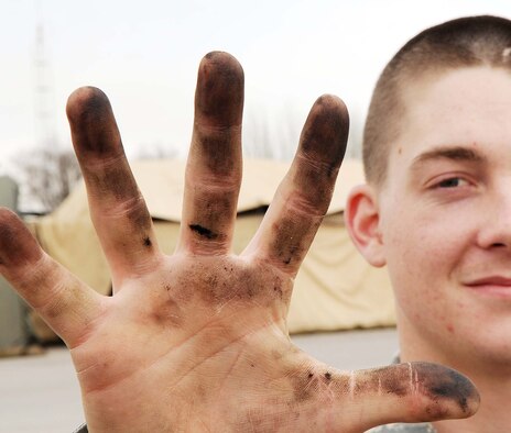 Airman 1st Class Jason Rayner 376th Expeditionary Logistics Readiness Squadron fuels journeyman shows how dirty his hands get from pumping fuel everyday. THe 376th ELRS broke their own record Feb. 18 by pumping 544,758 gallons of jet fuel in a 24-hour period. The record the previous flight had pumped in that time frame until now was 501,662 gallons, a record set Oct. 8, 2009.(U.S. Air Force photo/Senior Airman Nichelle Anderson/released)