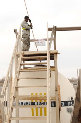 Airman 1st Class Cedric Gray 376th Expeditionary Logistics Readiness Squadron fuels journeyman checks fuel levels at the petroleum, oils, and lubricants yard,Transit Center at Manas Kyrgyzstan Feb. 23, 2010. Without Airmen working around the clock to get the fuel to the tankers, the mission would come to a screeching halt.(U.S. Air Force photo/Senior Airman Nichelle Anderson/released)