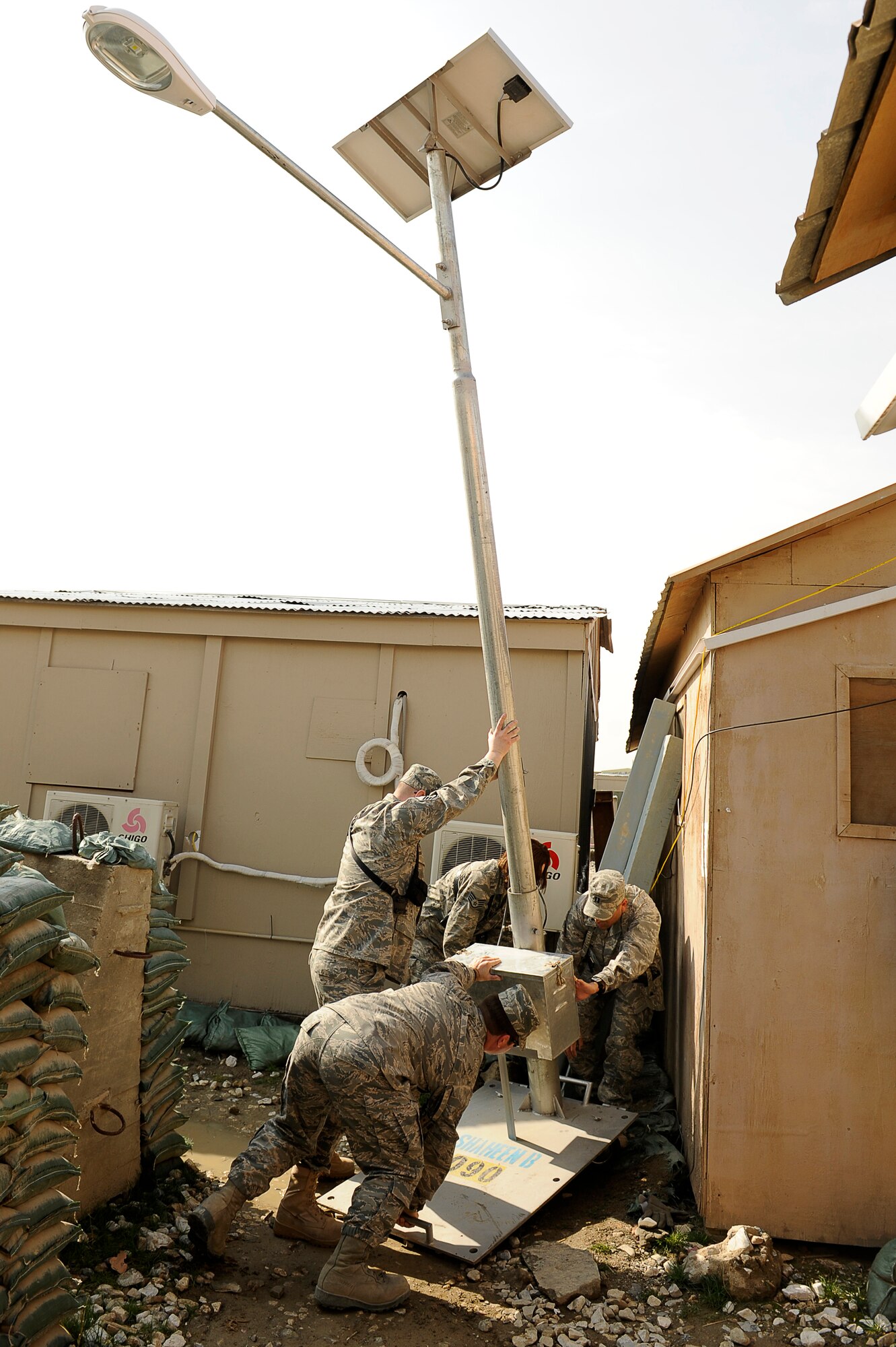 U.S. Air Force Airmen from the 455th Air Expeditionary Wing, Sexual Assault Response Coordinator office, raise a solar powered light at Bagram Airfield, Afghanistan, Feb. 23, 2010. (U.S. Air Force photo by/ Tech. Sgt. Jeromy K. Cross/released)