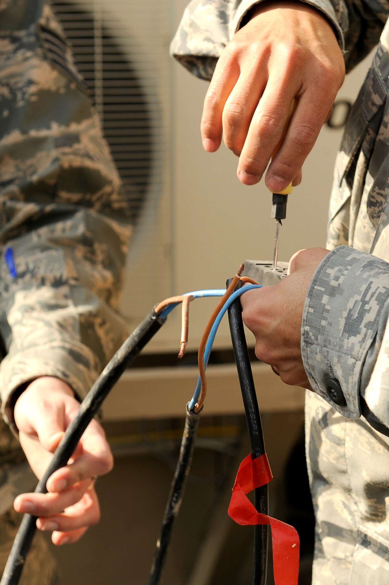 U.S. Air Force Airmen, 455th Air Expeditionary Wing, Sexual Assault Response Coordinator office, wire a solar powered light at Bagram Airfield, Afghanistan, Feb. 23, 2010. (U.S. Air Force photo by/ Tech. Sgt. Jeromy K. Cross/released)




