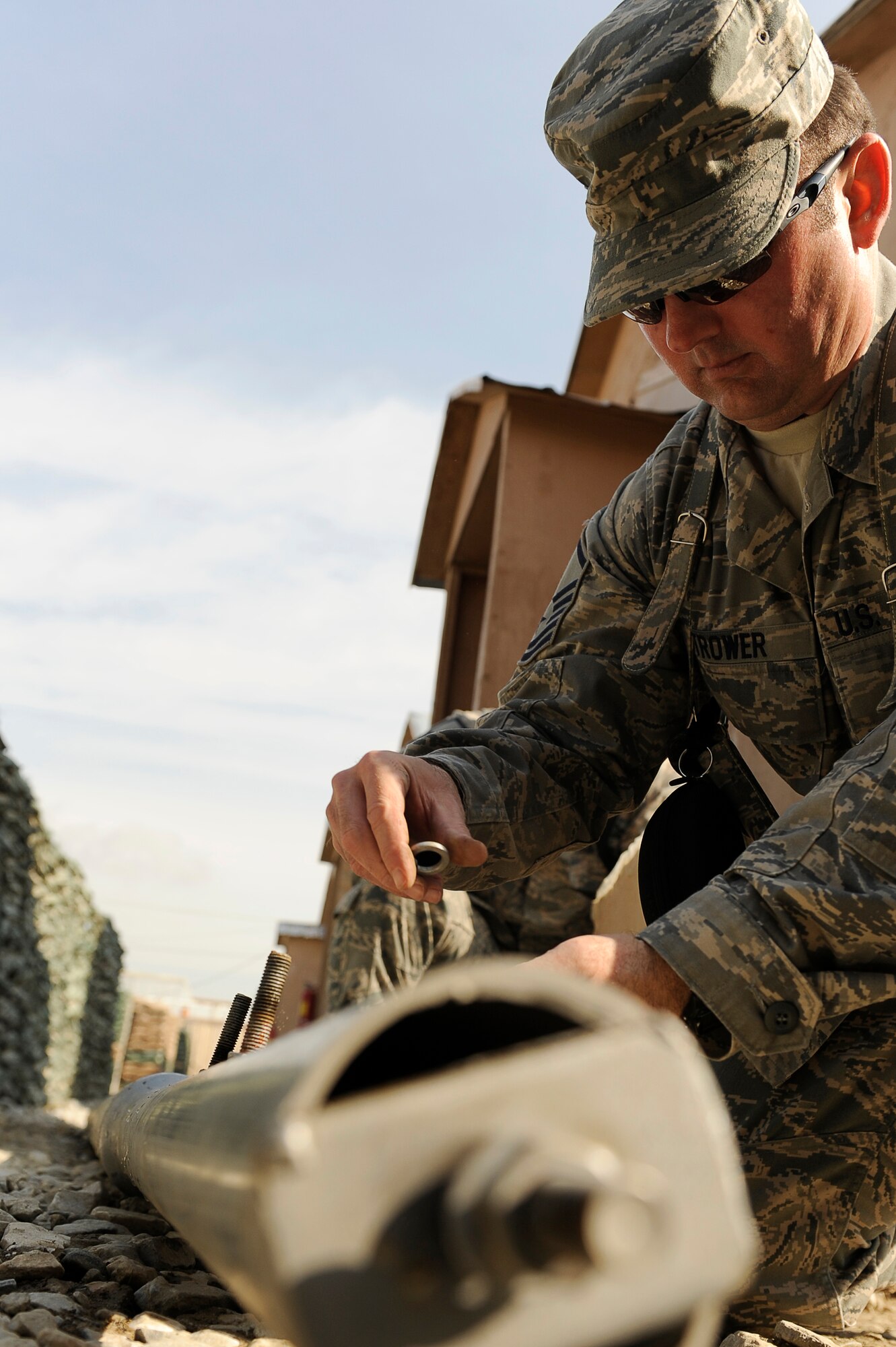 U.S. Air Force Master Sgt. Matthew Trower, 455th Air Expeditionary Wing, Equal Opportunity office, installs a solar powered light at Bagram Airfield, Afghanistan, Feb. 23, 2010. Sergeant Trower is deployed from Fairchild Air Force Base, Wash., and is from Liberty Lake, Wash. (U.S. Air Force photo by/ Tech. Sgt. Jeromy K. Cross/released)