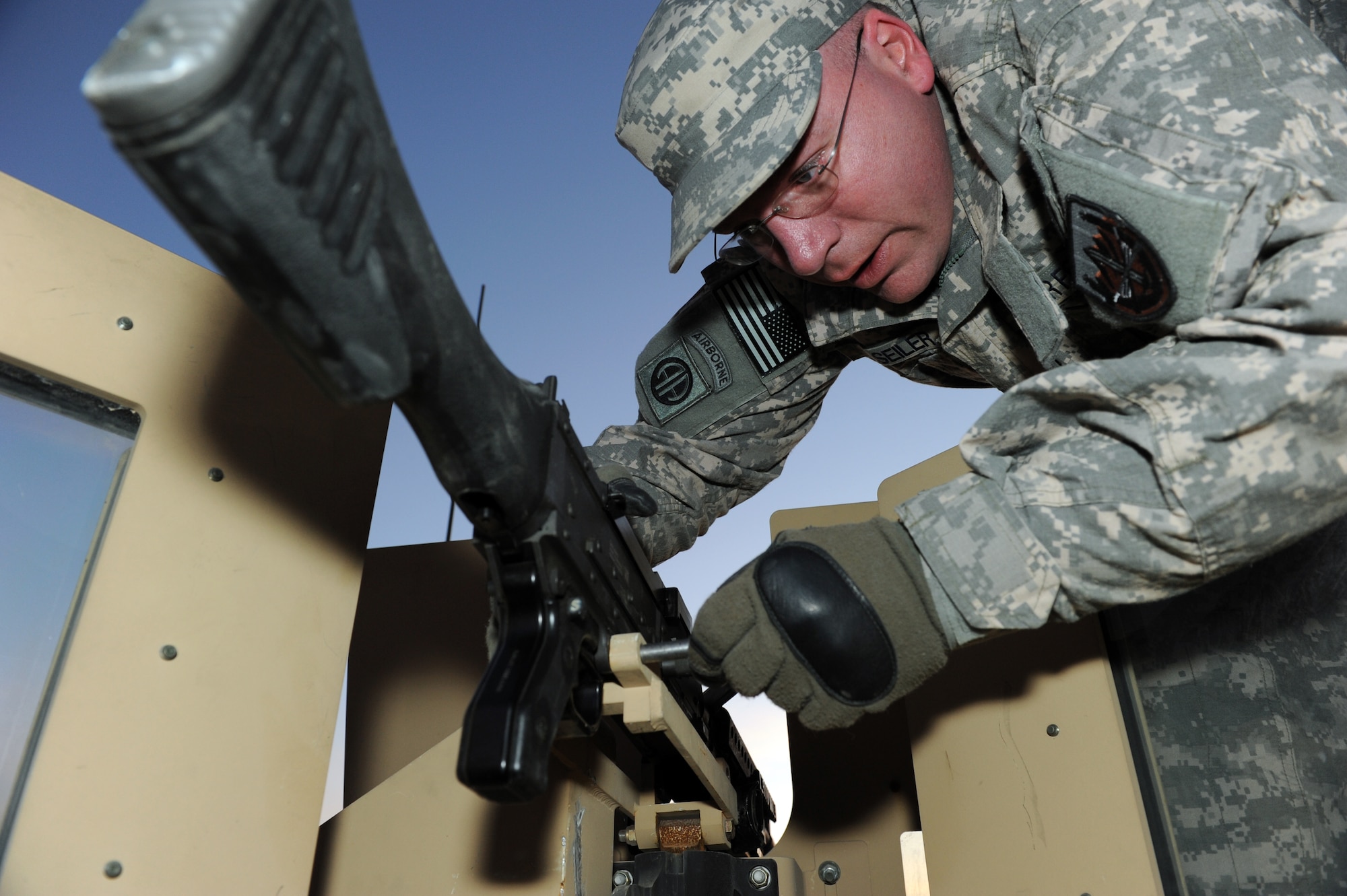 U.S. Air Force Master Sgt. Patrick Seiler installs a crew-served weapon during convoy preparations, Jan. 19, 2010. Sergeant Seiler is a resourse advisor/convoy driver assigned to the Combined Joint Task Force 82 Regional Support Team East and deployed from Ellsworth Air Force Base, S.D. (U.S. Air Force photo by/ Staff Sgt. Richard Williams)