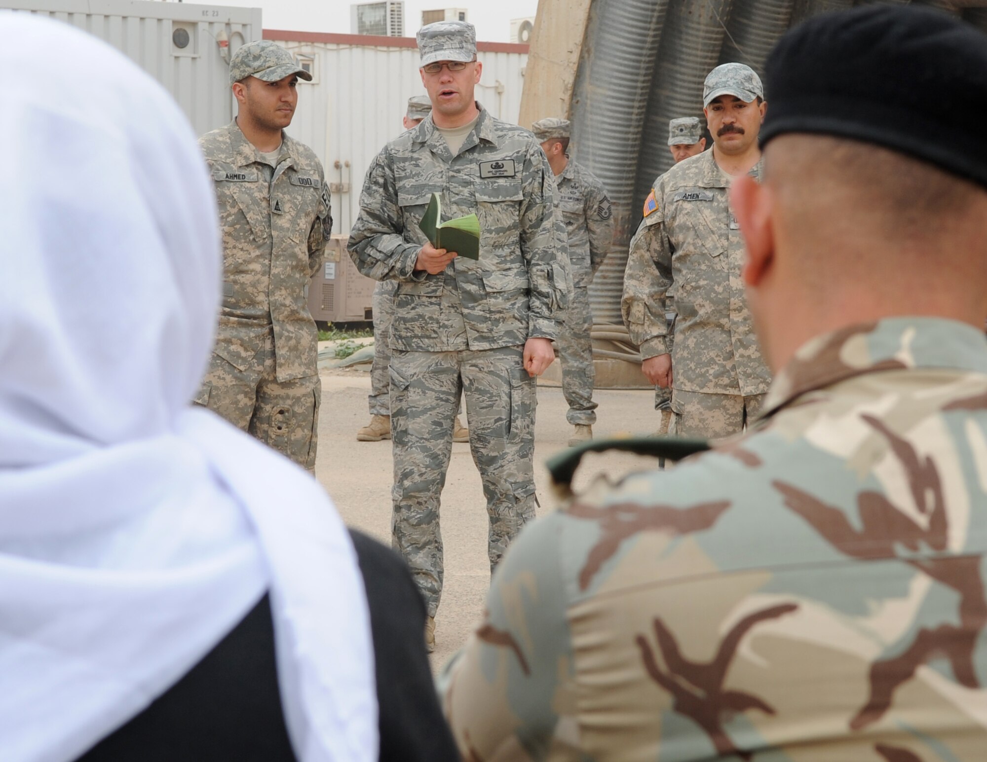 Members of the 506th Civil Engineer Squadron Explosive Ordnance Disposal team, memorialize three Iraqi Police Counter-explosive team members killed by a vehicle-borne IED on 12 August of last year by unveiling a mural painted in their honor at the EOD compound on Kirkuk Regional Air Base Feb. 23, 2010. The families of the fallen were presented donated funds raised during an EOD bomb suit run.  (U.S. Air Force photo/Staff Sgt. Tabitha Kuykendall/Released)