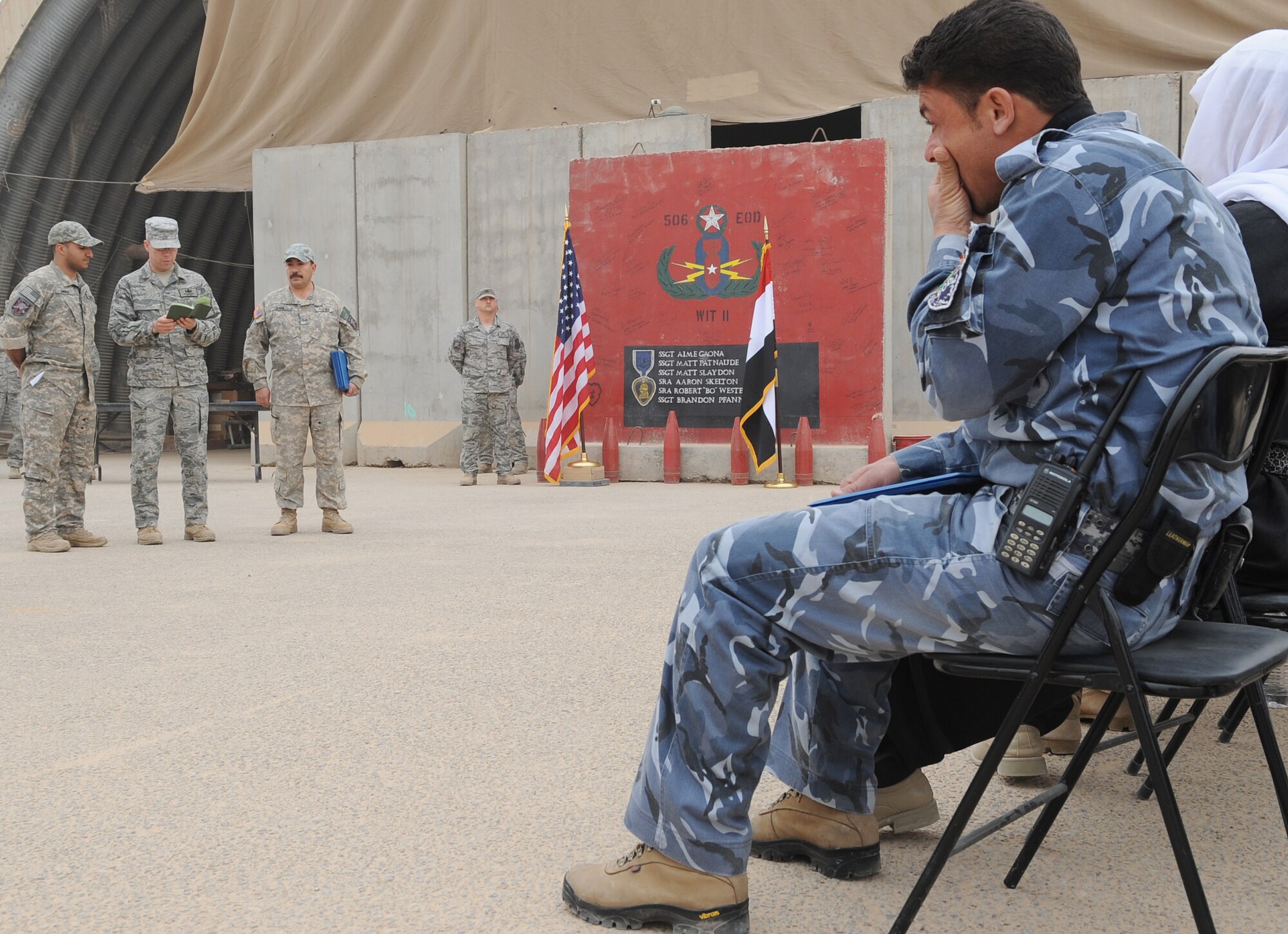 Members of the 506th Civil Engineer Squadron Explosive Ordnance Disposal team, memorialize three Iraqi Police Counter-explosive team members killed by a vehicle-borne IED on 12 August of last year by unveiling a mural painted in their honor at the EOD compound on Kirkuk Regional Air Base Feb. 23, 2010. The families of the fallen were presented donated funds raised during an EOD bomb suit run.  (U.S. Air Force photo/Staff Sgt. Tabitha Kuykendall/Released)