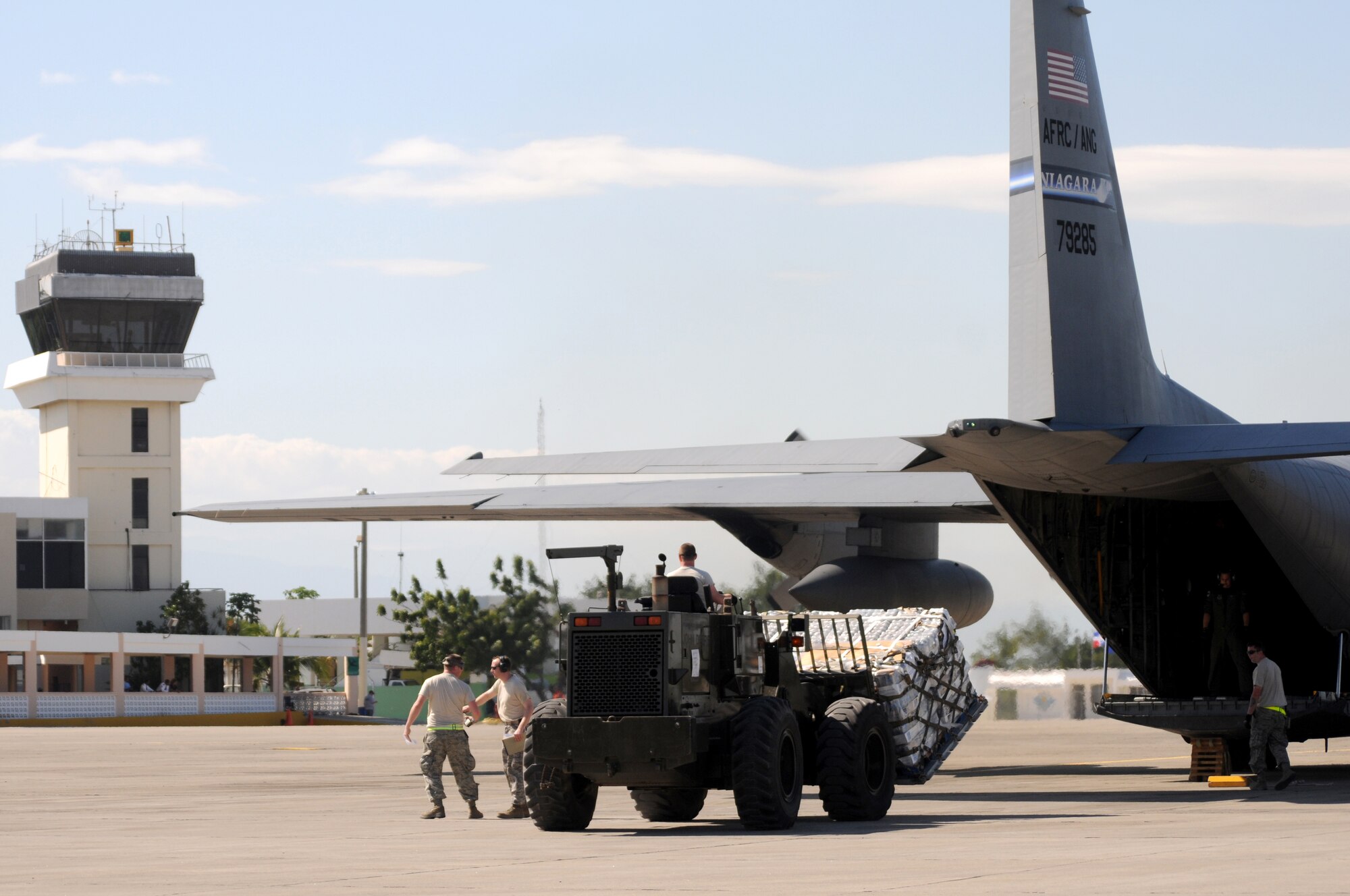 Airmen from the Kentucky Air National Guard?s 123rd Contingency Response Group offload emergency supplies from a New York Air Guard C-130 at an air hub in Barahona, Dominican Republic,  Jan. 25. The supplies will be convoyed to earthquake victims in Haiti. Volunteers and medical professionals from nongovernmental relief organizations are pouring in to the Dominican Republic to help with wounded Haitian refugees. (U.S. Air Force photo by Tech. Sgt. Dennis Flora)