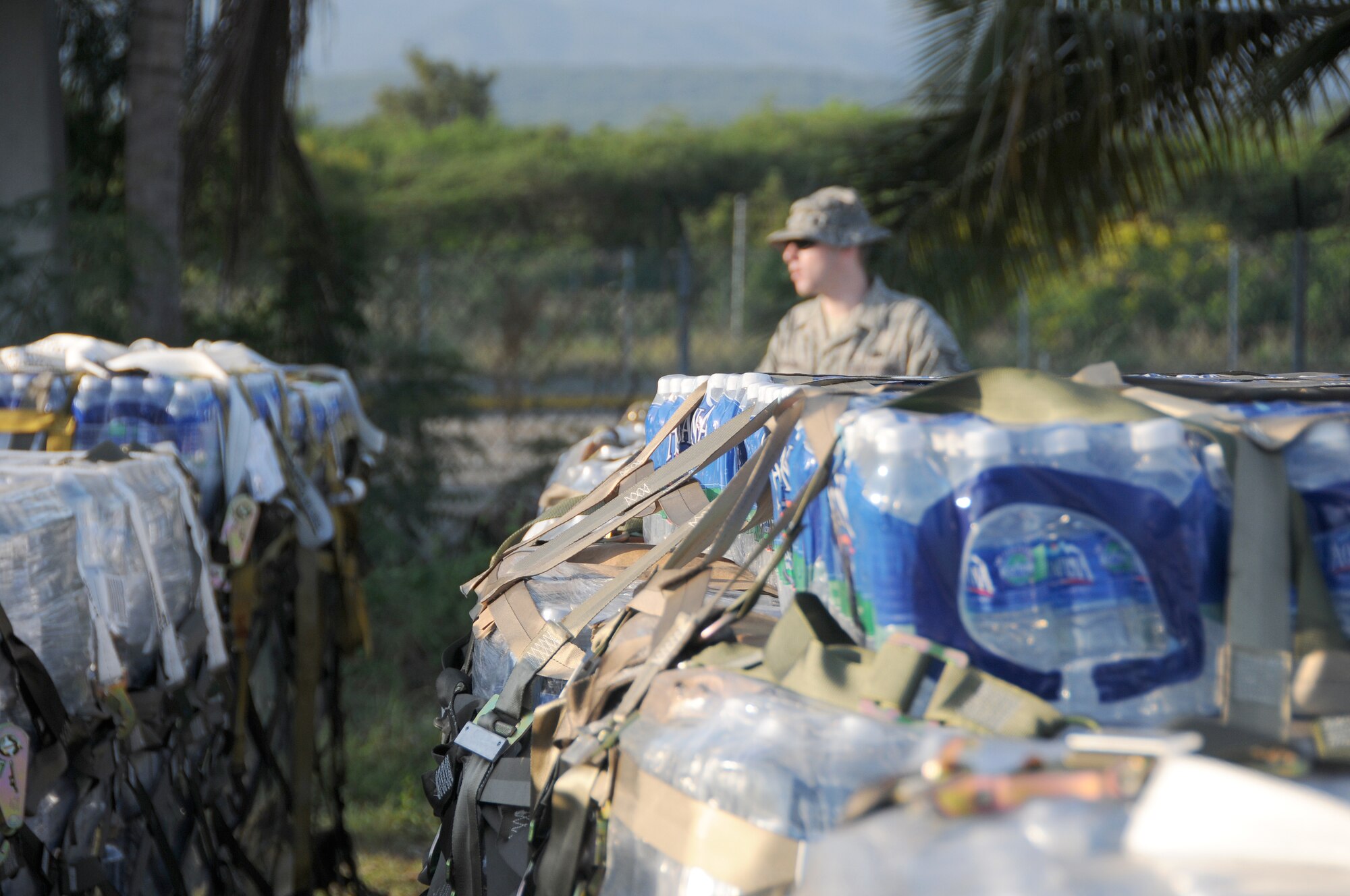 Tech. Sgt. Matthew Skeens from the Kentucky National Guard?s 123rd Contingency Response Group conducts an inventory of water at an air hub in Barahona, Dominican Republic,  Jan. 24. The water is to be shipped to earthquake victims in Haiti. (U.S. Air Force photo by Tech. Sgt. Dennis Flora)
