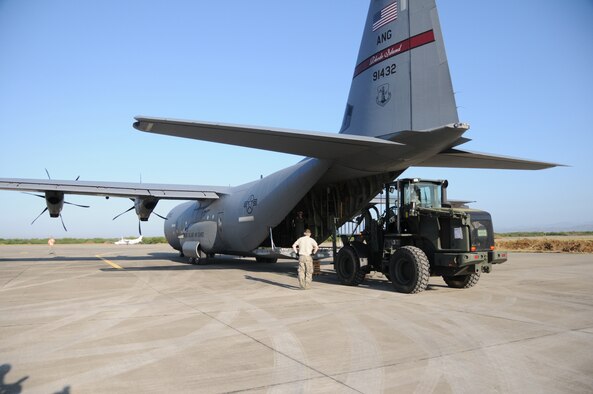 Airmen from the Kentucky National Guard?s 123rd Contingency Response Group unload a Rhode Island C-130 aircraft delivering emergency supplies for the earthquake victims in Haiti at an air hub in Barahona, Dominican Republic,  on Jan. 25. Volunteers and medical professionals from nongovernmental relief organizations are pouring in to the Dominican Republic to help with the wounded Haitian refugees.  The Guardsmen established the air hub Jan. 22 to process inbound humanitarian aid for victims of the earthquake. (U.S. Air Force photo by Tech. Sgt. Dennis Flora)
