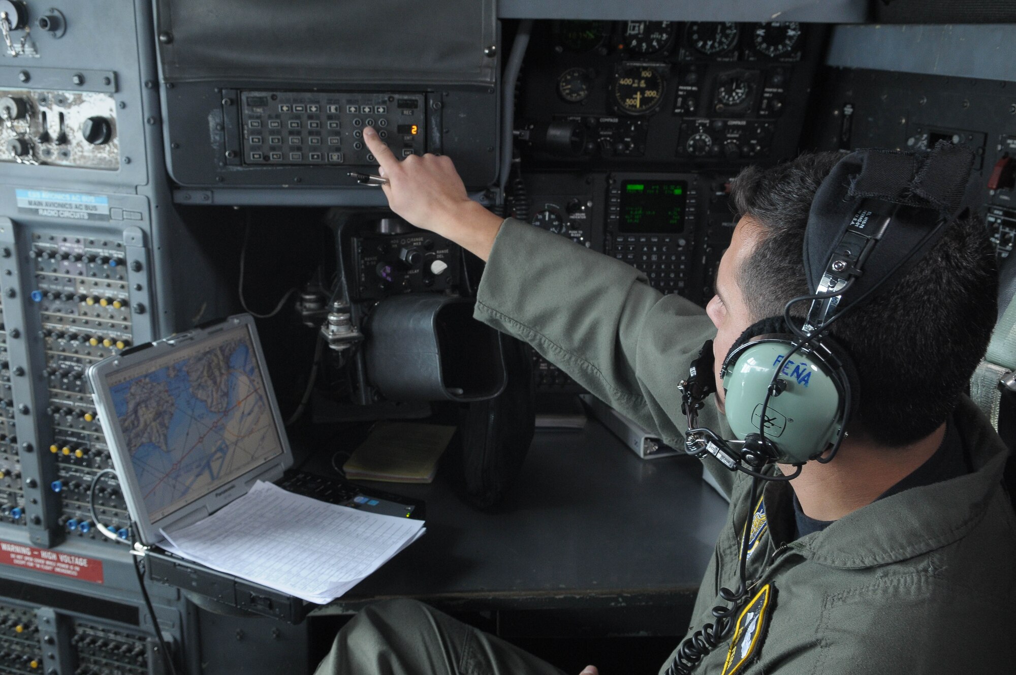 KADENA AIR BASE, Japan -- Capt. Aron Pena, 36th Airlift Squadron navigator, enters in data in flight Feb. 23. as part of a bilateral training mission at Kadena Air Base. (U.S. Air Force photo/Airman 1st Class Sean Martin).