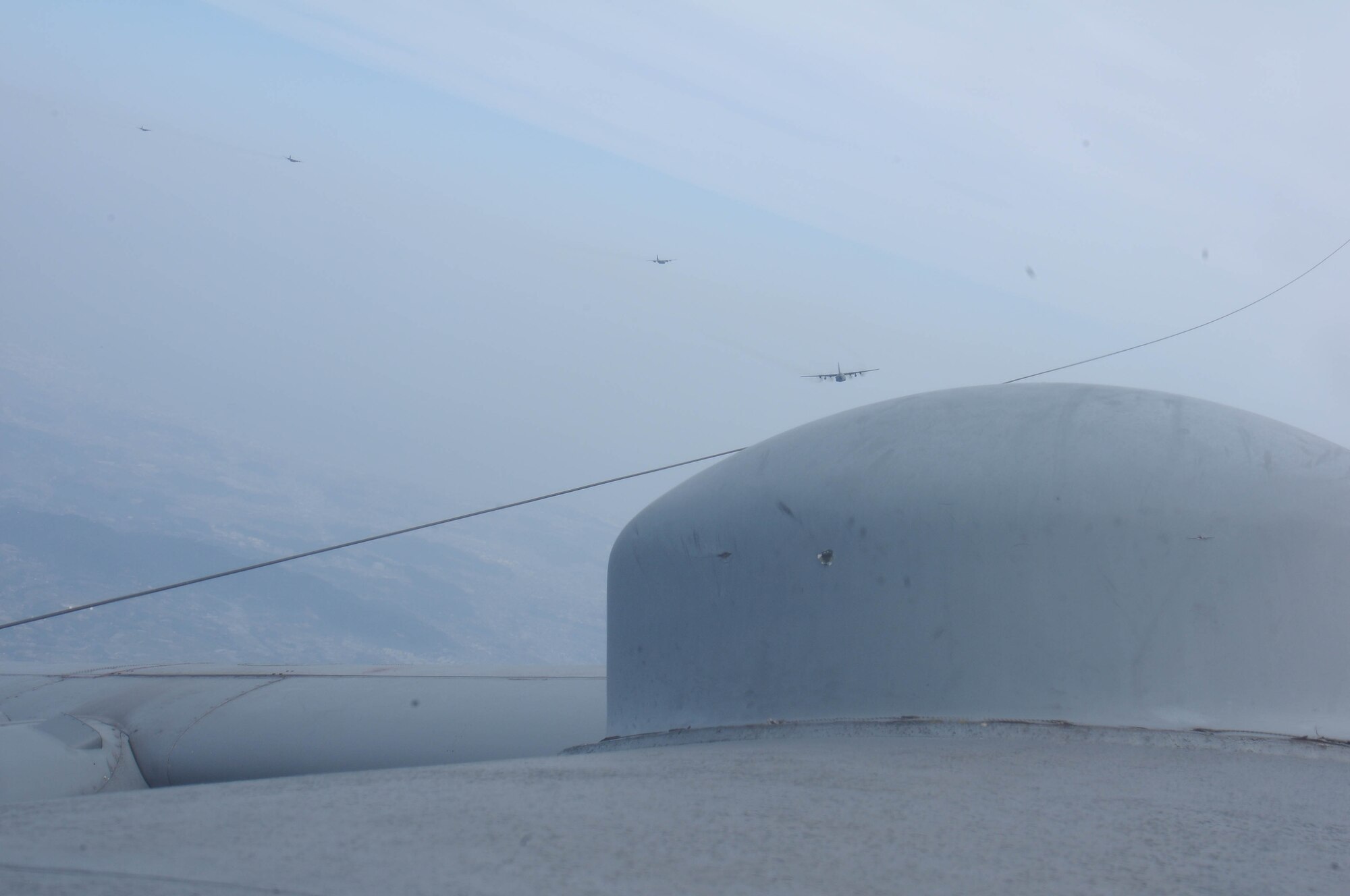 KADENA AIR BASE, Japan -- Yokota Air Base C-130's fly in formation Feb. 23 during joint, bilateral training at Kadena Air Base, Japan as seen from the bubble on the lead plane. (U.S. Air Force photo/Airman 1st Class Sean Martin)