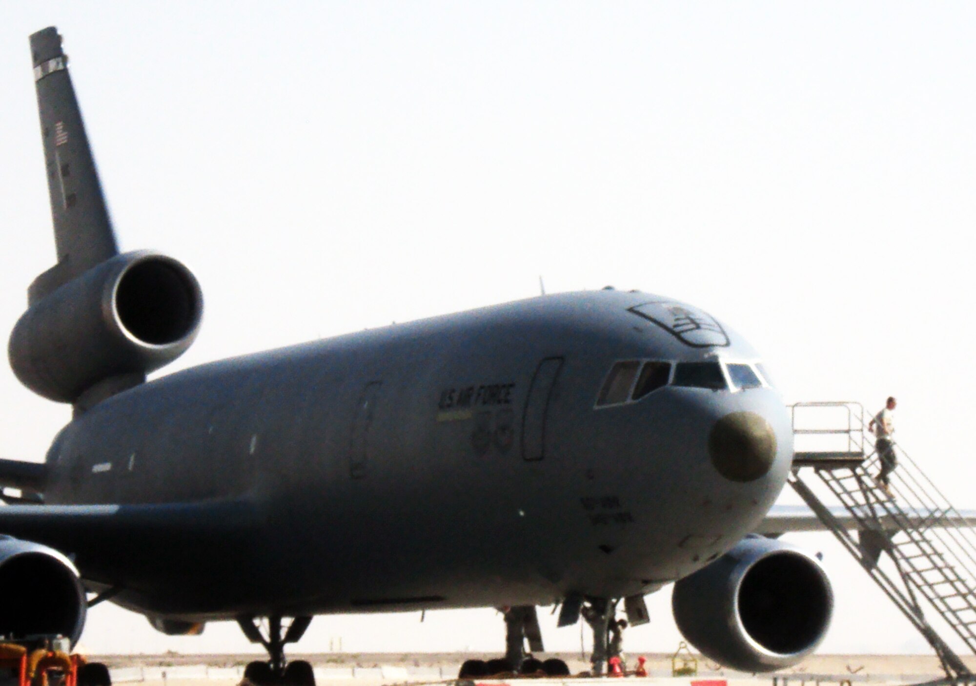 A maintenance Airman climbs down the air stairs from a KC-10 Extender during flightline operations at a non-disclosed base in Southwest Asia on Feb. 19, 2010.  The KC-10 Extender is a part of the 908th Expeditionary Air Refueling Squadron of the 380th Air Expeditionary Wing. KC-10s assigned to the 908th EARS fly combat air refueling missions in support of Operations Enduring Freedom, the Combined Joint Task Force-Horn of Africa and Operation Iraqi Freedom. The KC-10 is the Air Force's largest tanker and in 2009, aircraft assigned to the 908th EARS flew more than 4,700 combat missions offloading more than 422 million pounds of fuel to more than 31,400 aircraft.  (U.S. Air Force Photo/Master Sgt. Scott T. Sturkol/Released)
