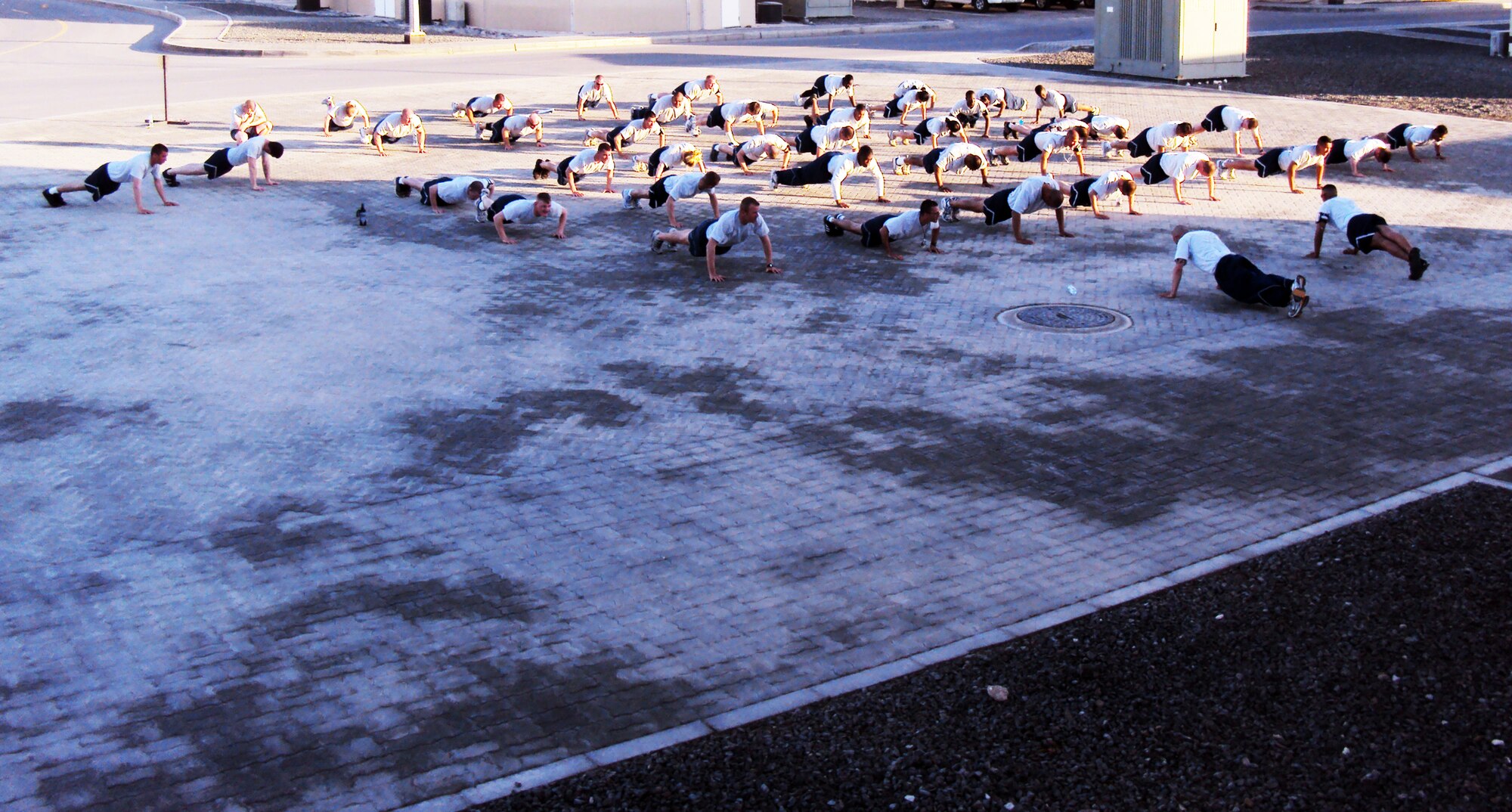 Airmen assigned to the 380th Air Expeditionary Wing perform push-ups during an outdoor physical training session at a non-disclosed location in Southwest Asia on Feb. 2010. The 380th AEW supports operations Iraqi Freedom and Enduring Freedom and the Combined Joint Task Force-Horn of Africa.  (U.S. Air Force Photo/Master Sgt. Scott T. Sturkol/Released)