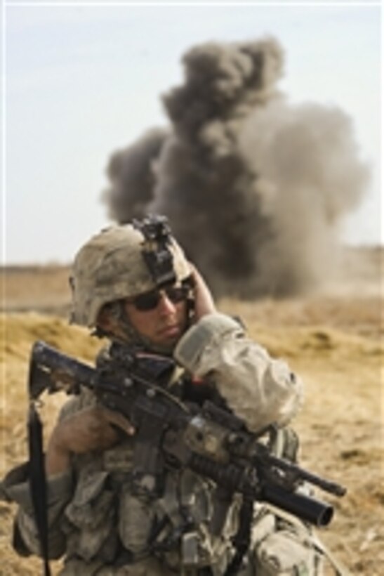 A U.S. Army soldier with Alpha Company, 1st Battalion, 17th Infantry Regiment covers his ear as a controlled detonation destroys an improvised explosive device during Operation Helmand Spider in Badula Qulp, Afghanistan, on Feb. 23, 2010.  