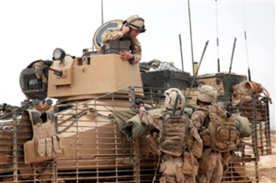 U.S. Marines, bottom, talk to a British soldier near Marja, Afghanistan, Feb. 21, 2010. The Marines, assigned to Charlie Company, 1st Battalion, 3rd Marine Regiment, and British soldiers are working together to clear the area of Taliban forces.