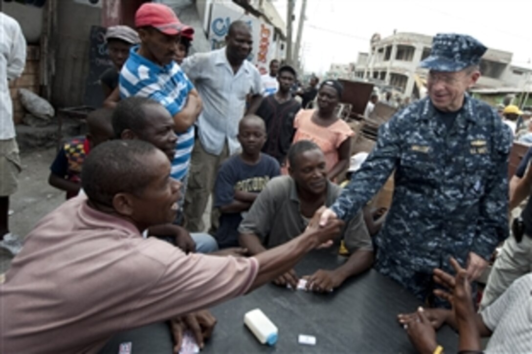 Navy Adm. Mike Mullen, chairman of the Joint Chiefs of Staff, meets with local citizens in Port-au-Prince, Haiti, on Feb. 26, 2010. Mullen is visiting Haiti to observe humanitarian missions being performed by U.S. servicemembers.