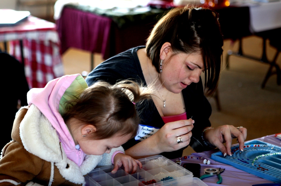 Brittanie Harrison, military spouse and crafts specialist, strings jewelry creations with her daughter during the Spouse Networking Day at the Stone Street Community Center, Feb. 27. The event brought spouses together to trade job ideas and career tips, the program opens peoples’ eyes to starting their own business out of their homes.