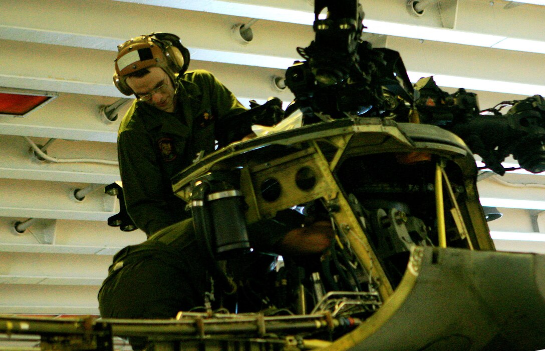 Sgt. Michael Zandaki, a phase crew quality assurance technician with Marine Medium Helicopter Squadron Reinforced (HMM-265 (REIN), 31st Marine Expeditionary Unit (MEU), inspects a CH-46 Sea Knight helicopter’s flight control unit during scheduled maintenance aboard the forward deployed amphibious assault ship USS Essex (LHD-2), Feb. 27. The MEU recently completed Exercise Cobra Gold 2010 (CG ’10) and is currently scheduled to go underway to the Republic of the Philippines in support of Exercise Balikatan 2010 (BK ’10).