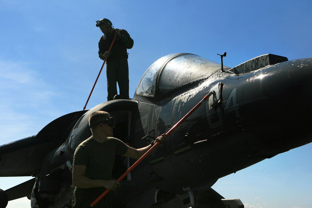 Cpl. Aaron Neal and Gunnery Sgt. Leslie T. Gill, both with Marine Attack Squadron 311 (VMA-311), 31st Marine Expeditionary Unit (MEU), wash an AV-8B Harrier II jet for a weekly inspection aboard the forward-deployed amphibious assault ship USS Essex (LHD-2), Feb. 26. VMA-311 is the fixed-wing attack component of the Aviation Command Element (ACE) attached to the MEU. The MEU recently completed Exercise Cobra Gold 2010 (CG ’10) and is currently scheduled to go underway to the Republic of the Philippines in support of Exercise Balikatan 2010 (BK ’10).