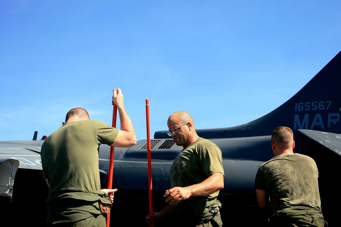 Marines with Marine Attack Squadron 311 (VMA-311), 31st Marine Expeditionary Unit (MEU), wash an AV-8B Harrier II for a weekly inspection aboard the forward-deployed amphibious assault ship USS Essex (LHD-2), Feb. 26. VMA-311 is the fixed-wing attack component of the Aviation Command Element (ACE) attached to the MEU. The MEU recently completed Exercise Cobra Gold 2010 (CG ’10) and is currently scheduled to go underway to the Republic of the Philippines in support of Exercise Balikatan 2010 (BK ’10).