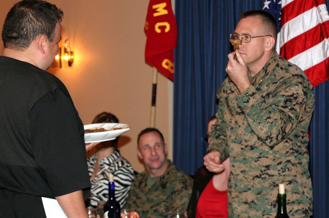 FORT WORTH, Texas (Feb. 29, 2009) --Major Patrick R. Crawford, commanding officer of Recruiting Station Fort Worth, smells steak during a dinner called "Dining Out" here. Crawford held the President of the mess during the affair and his job was to run the meeting and inspect the food to see if it was sutible for consumption. (U.S. Marine Corps photo by Sgt. Ray Lewis)