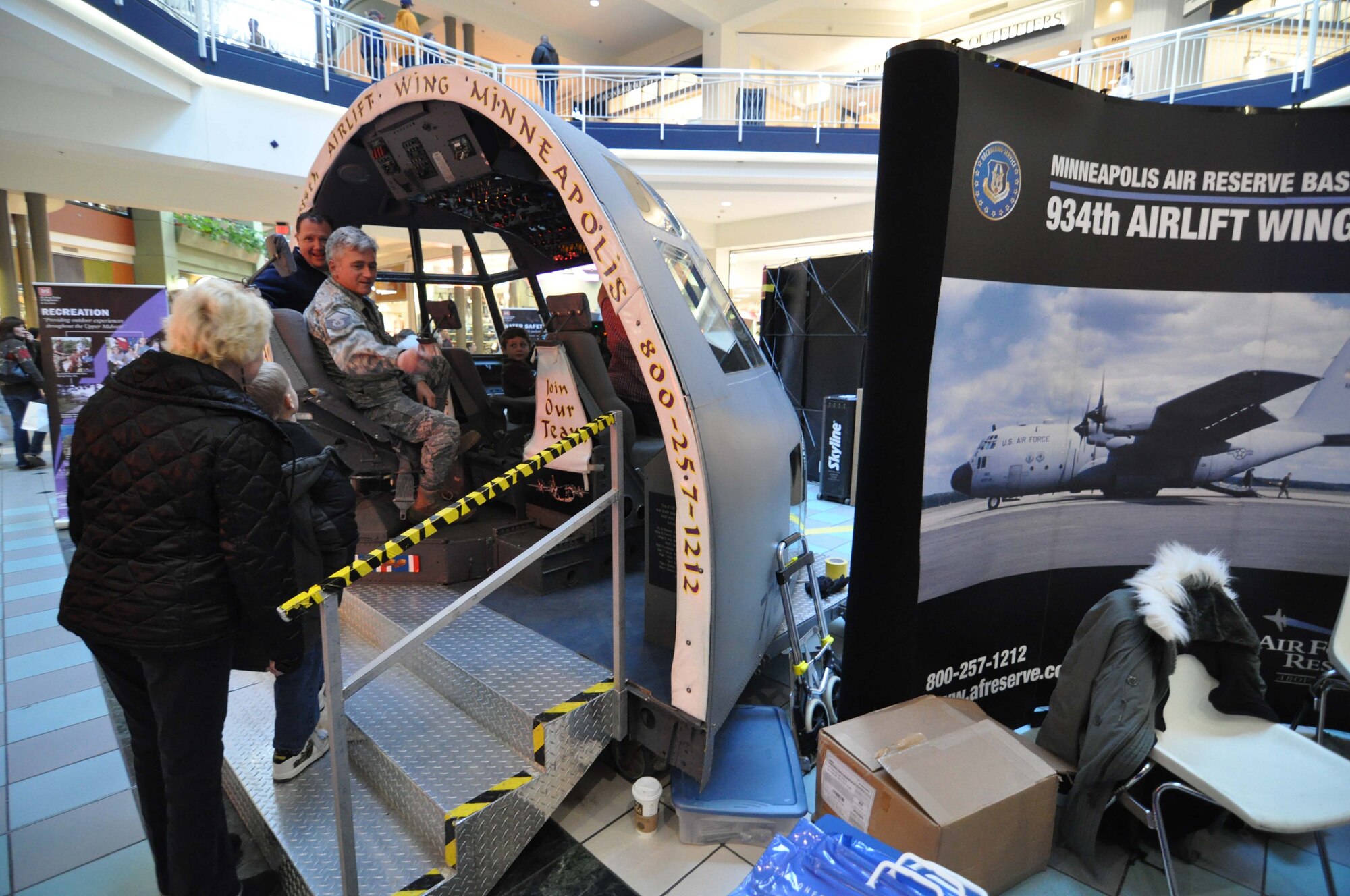 Master Sgt. Alan McCann, 934th Maintenance Squadron, shows off the C-130 flight deck display to shoppers at the Mall of America Jan. 31. The display included a 934th Recruiting Squadron display and was part of the annual Government on Display event at the mall. (Air Force Photo/Master Sgt. Paul Zadach