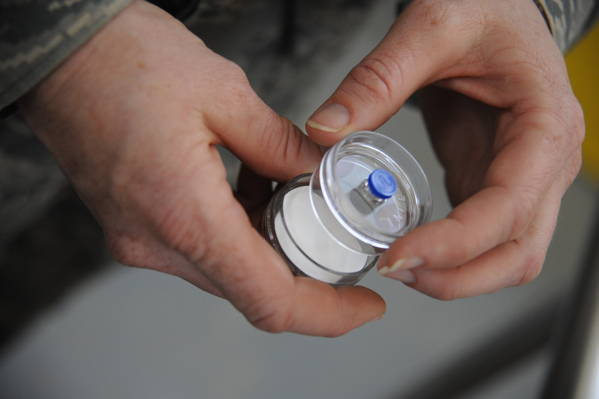 U.S. Air Force Tech. Sgt. Kathleen Franklin, 821st  Expeditionary Training Squadron petroleum oil & lubrication class advisor, holds a filter that is used to teach the Iraqi students how to test filtered fuel at Camp Taji, Iraq, Feb. 13, 2010. This POL class is advised by U.S. Air Force personnel who teach the Iraqi military how to be self sufficient in protecting their equipment and personnel while checking fuel for contaminants that can be potentially hazardous. (U.S. Air Force photo/Master Sgt. Trish Bunting/Released)