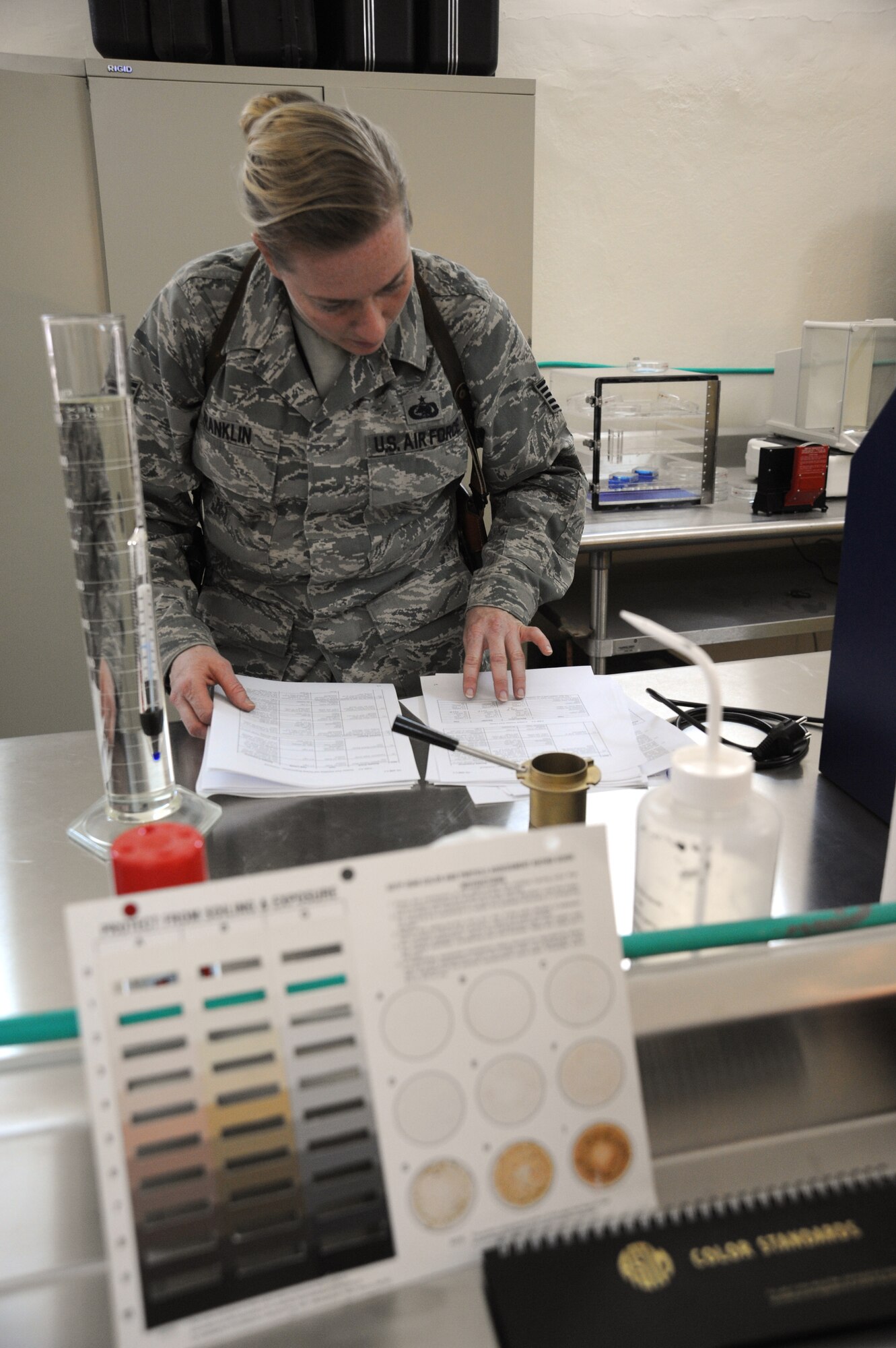 U.S. Air Force Tech. Sgt. Kathleen Franklin, 821st Expeditionary Training Squadron petroleum oil & lubrication class advisor, researches a question that was asked by an Iraqi student during class at Camp Taji, Iraq, Feb. 13, 2010. This POL class is advised by U.S. Air Force personnel who teach the Iraqi military how to be self sufficient in protecting their equipment and personnel while checking fuel for contaminants that can be potentially hazardous. (U.S. Air Force photo/Master Sgt. Trish Bunting/Released)