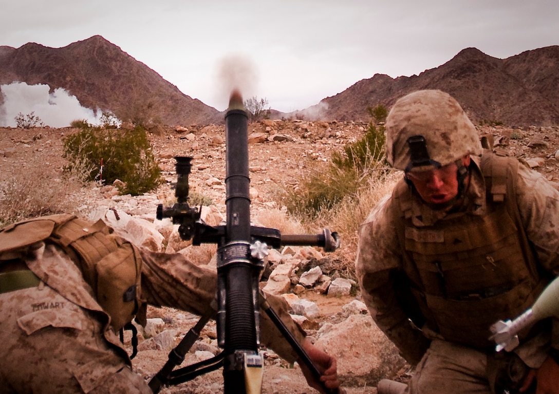 Lance Cpls. Kenneth Cowart and Luke R. Cutsforth, mortar men with Weapons Platoon, India Company, 3rd Battalion, 3rd Marine Regiment, fire mortars during a company assault exercise at Range 400 at Marine Corps Air Ground Combat Center Twentynine Palms, Calif. Feb. 28. Cowart is a native of Fayetville, Ga. Cutsforth is a native of Dilling, Mont.