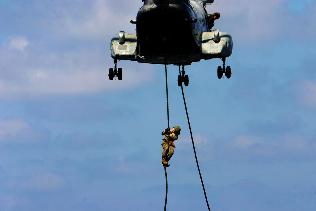 A Marine with Battalion Landing Team 2nd Battalion, 7th Marines (BLT 2/7), 31st Marine Expeditionary Unit (MEU), participates in fast ropes operations from a CH-46E Sea Knight helicopter and onto the flight deck of the forward-deployed amphibious assault ship USS Essex (LHD 2), Feb. 28. The MEU is currently underway to the Republic of the Philippines in support of Exercise Balikatan 2010 (BK ’10).