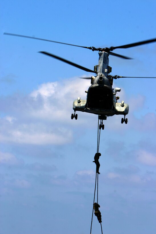 Marines with Battalion Landing Team 2nd Battalion, 7th Marines (BLT 2/7), 31st Marine Expeditionary Unit (MEU), descend from a CH-46E Sea Knight helicopter during fast rope operations onto the flight deck of the forward-deployed amphibious assault ship USS Essex (LHD 2), Feb. 28. The MEU is currently underway to the Republic of the Philippines in support of Exercise Balikatan 2010 (BK ’10).