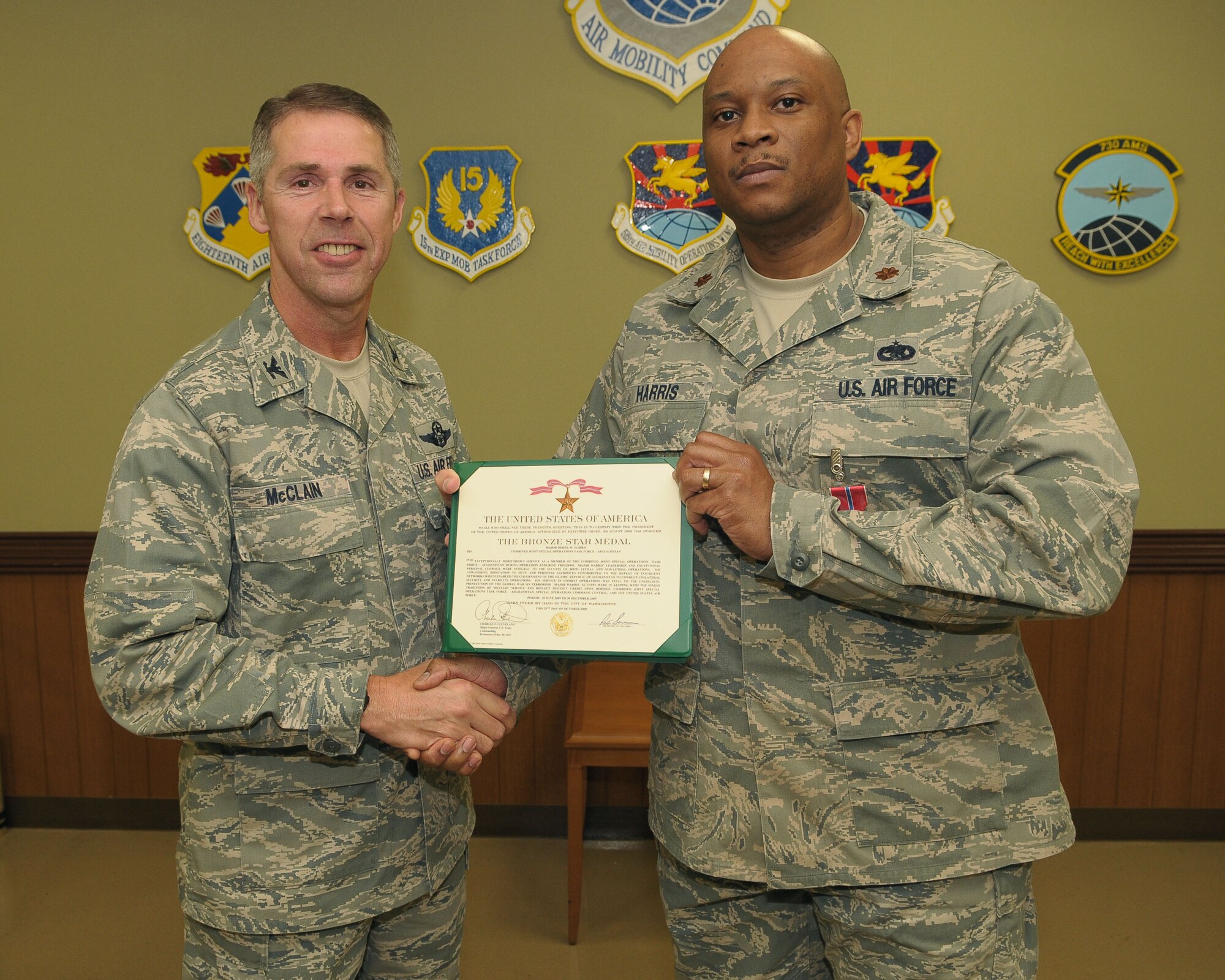 YOKOTA AIR BASE, Japan -- Maj. Derek Harris ,730th Air Mobility Squadron director of operations, receives the Bronze Star Feb. 25 during a presentation ceremony. The Bronze Star Medal is awarded to individuals for acts of heroism or meritorious achievement in ground combat. (U.S. Air Force photo/Airman 1st Class Sean Martin) 