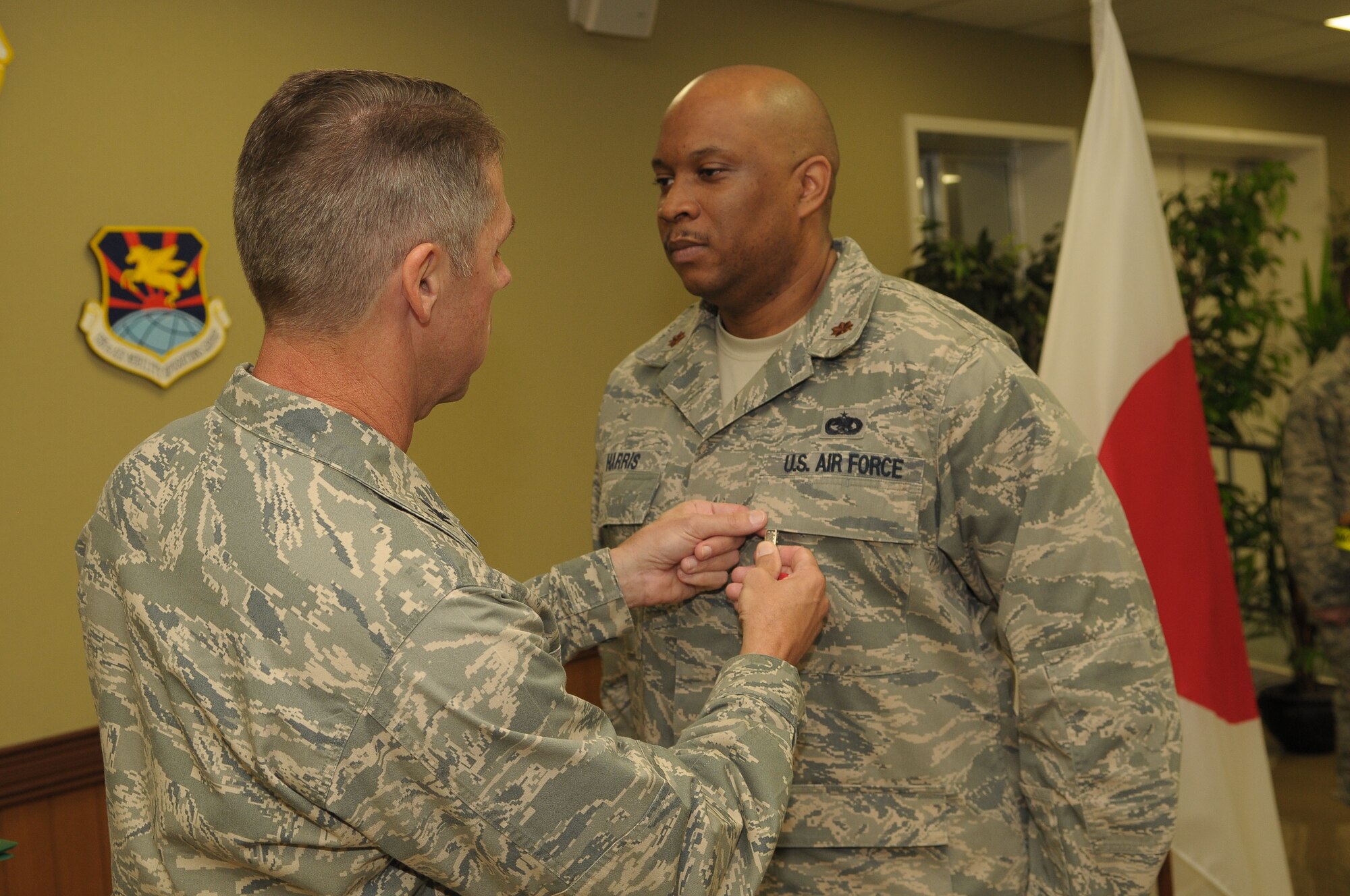 YOKOTA AIR BASE, Japan -- Maj. Derek Harris ,730th Air Mobility Squadron director of operations, receives the Bronze Star Feb. 25 during a presentation ceremony. The Bronze Star Medal is awarded to individuals for acts of heroism or meritorious achievement in ground combat. (U.S. Air Force photo/Airman 1st Class Sean Martin) 