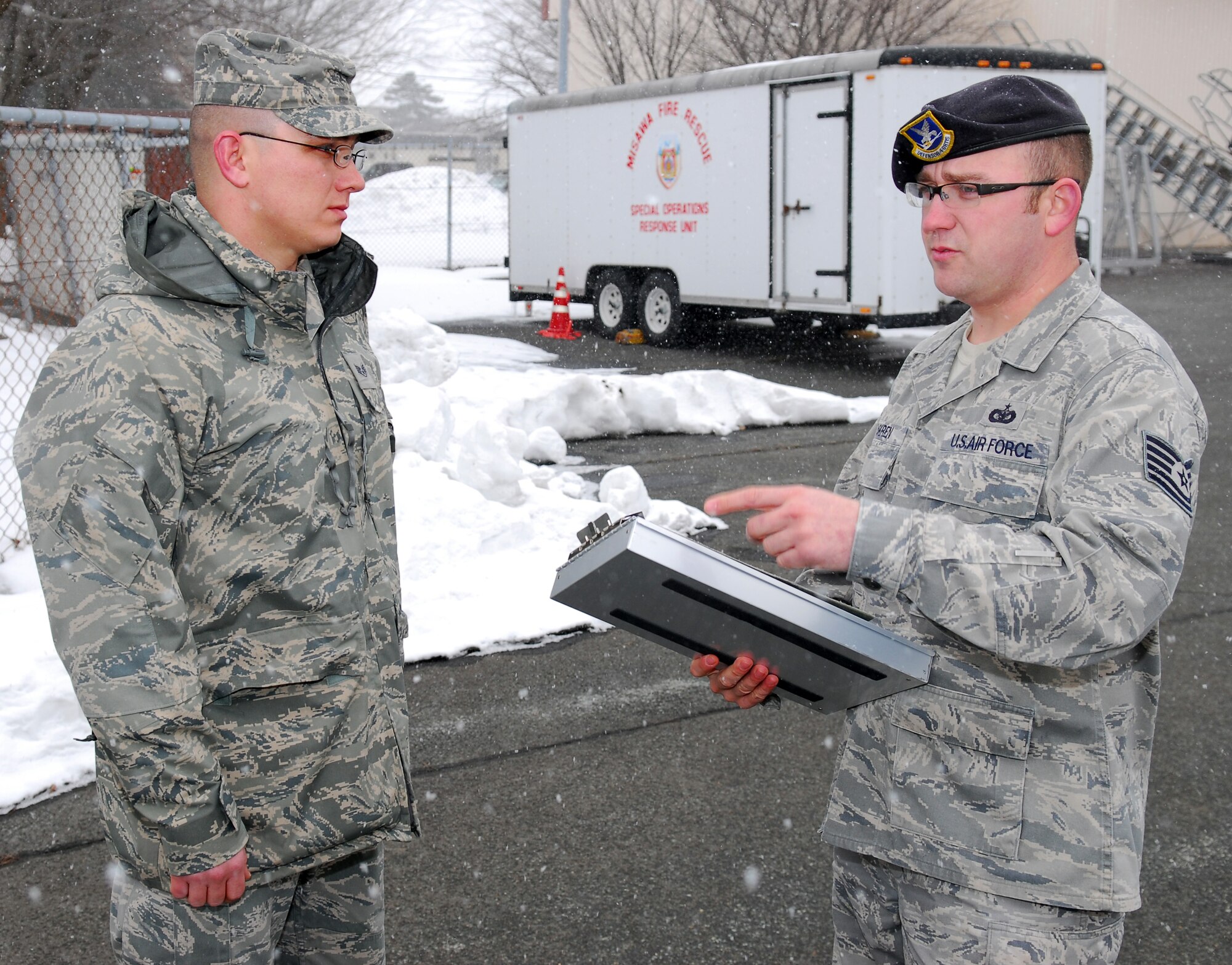 MISAWA AIR BASE, Japan – Tech. Sgt. Tyrel Askren, 35th Fighter Wing Antiterrorism Office alternate antiterrorism officer, discusses facility standoff procedures Feb. 5 with Staff Sgt. Jonathon Strom, 35th Force Support Squadron First Term Airmen’s Center NCO in charge, in the Airmen’s Center parking lot. Antiterrorism considerations are key to all facilities found on Misawa. (U.S. Air Force photo\Staff Sgt. Phillip Butterfield) 