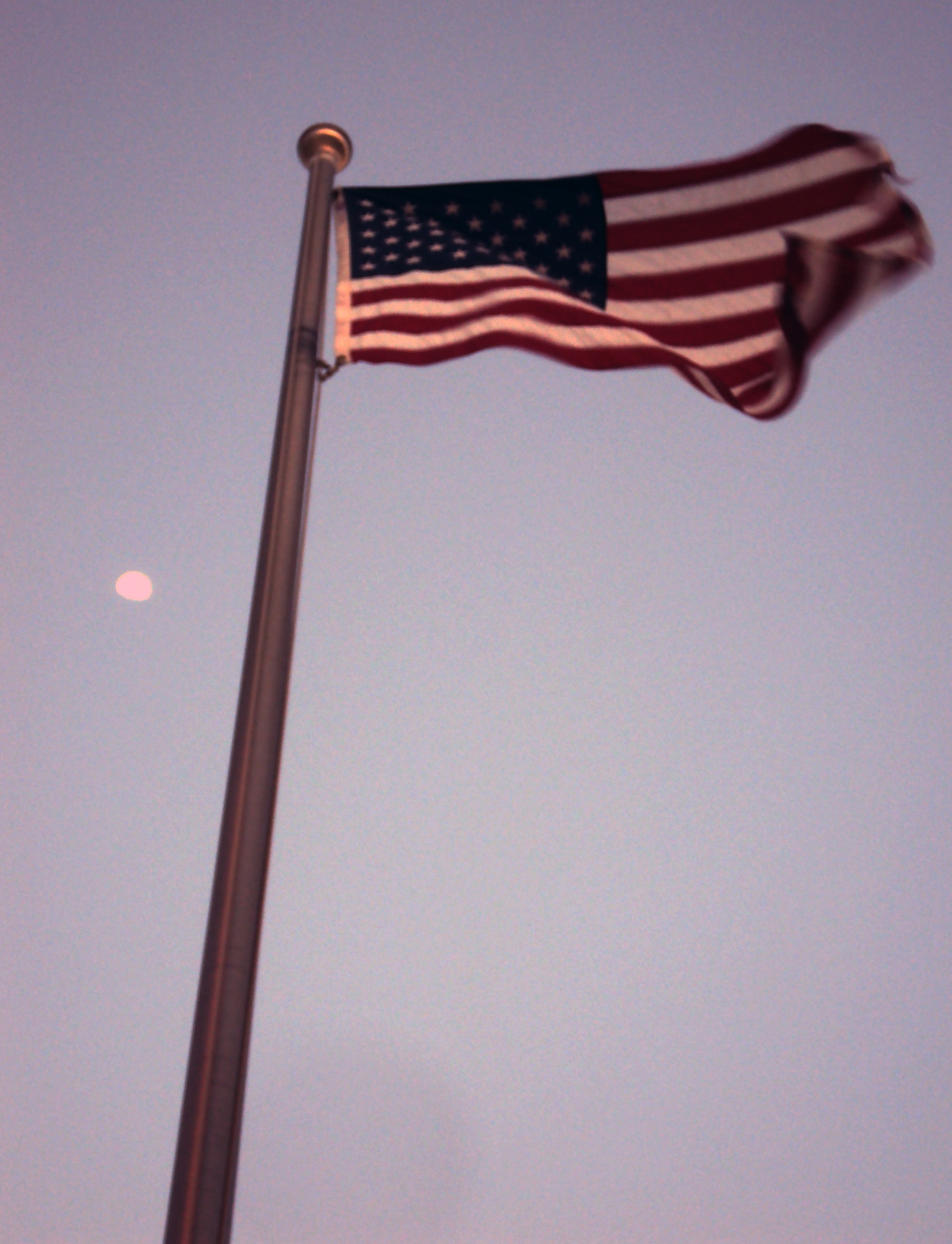 The American flag flying in front of the 380th Air Expeditionary Wing headquarters is backdropped by the rising moon at a non-disclosed base in Southwest Asia on Feb. 24, 2010. (U.S. Air Force Photo/Master Sgt. Scott T. Sturkol/Released)