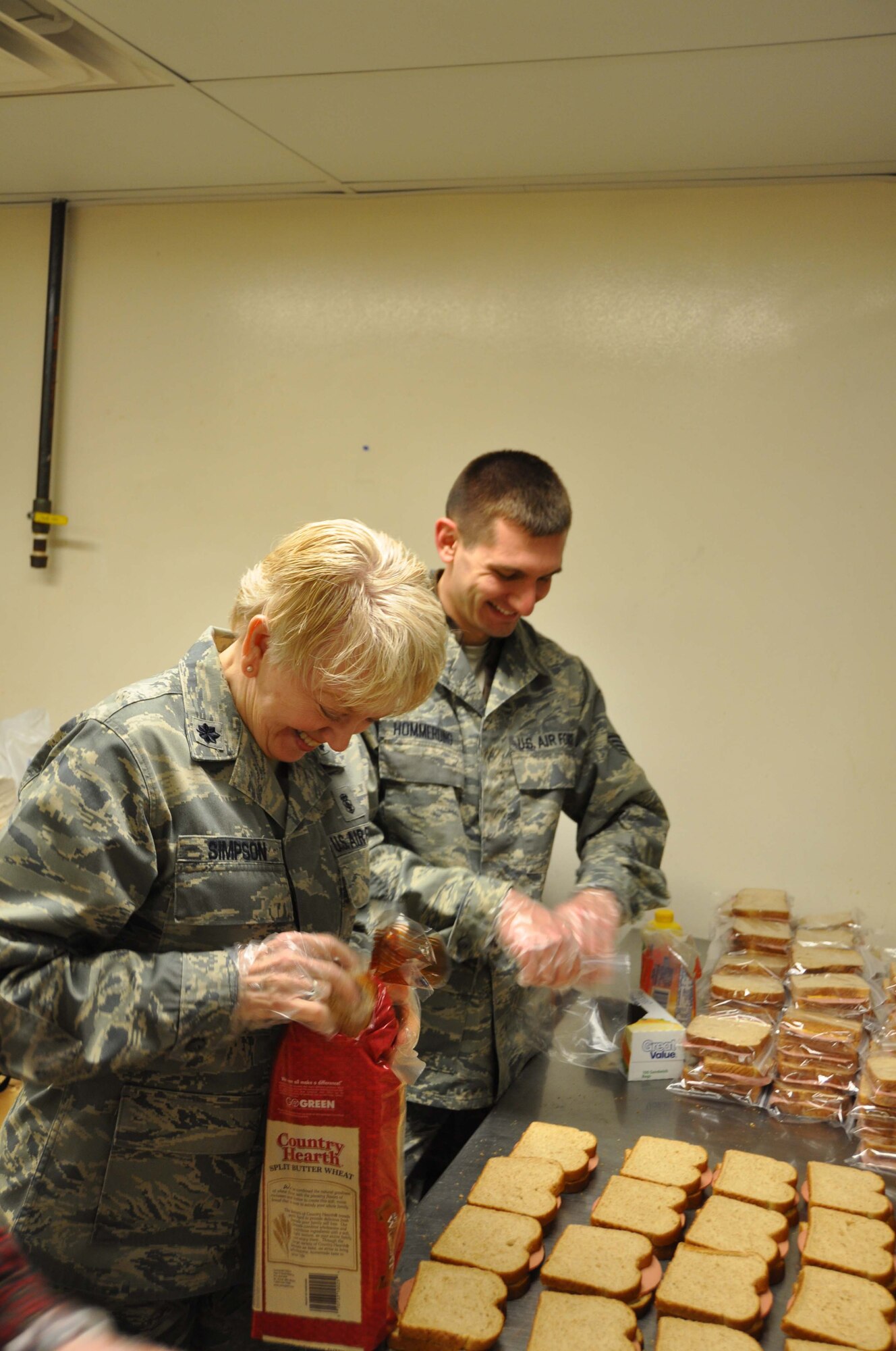 Lt. Col. Sharon Simpson and Staff Sgt. Aaron Hommerding, both from the 934th Aeromedical Staging Squadron, prepare sandwiches as part of a Human Resources Development Council initiative to support the 363 Days program which provides sandwiches to homeless people in the Twin Cities. Colonels Toby Hammer and Mark Vijums provided the supplies - lunchmeat, turkey, cheese, mustard and bread. Vilson Wilson of the Services Club provided use of the club?s kitchen for food preparation and storage.(Air Force Photo/Tech. Sgt. Jeffrey Williams)
