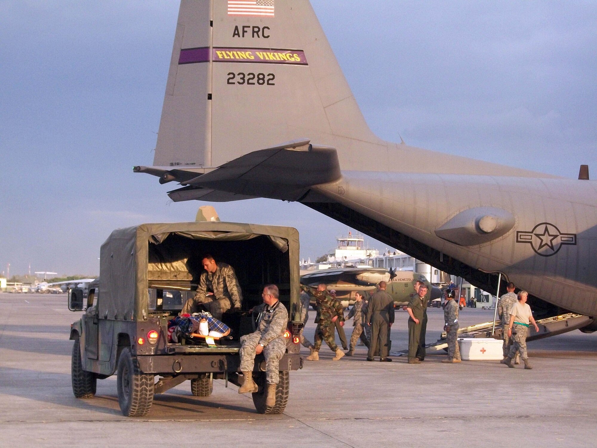 934th Airlift Wing members pick up patients and drop off supplies at Toussaint L?ouverture International Airport, Port-auPrince, Haiti, Jan. 26. (Air Force Photo/Lt. Col. Craig Trammell).