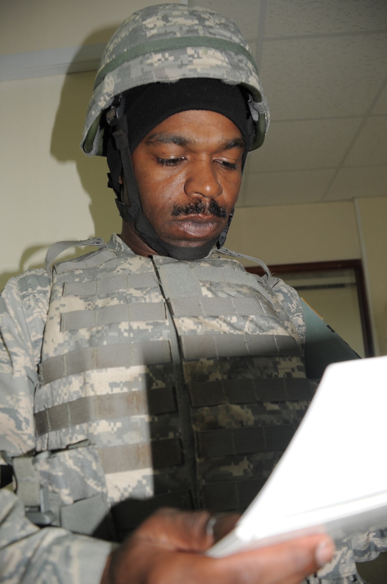 Tech. Sgt. Andre Scott of the 380th Expeditionary Security Forces Squadron runs through checklist while wearing his protective armor during a security forces training exercise Feb. 20, 2010, at a non-disclosed base in Southwest Asia.  Sergeant Scott is deployed from the 436th Security Forces Squadron at Dover Air Force Base, Del. (U.S. Air Force Photo/Master Sgt. Scott T. Sturkol/Released)