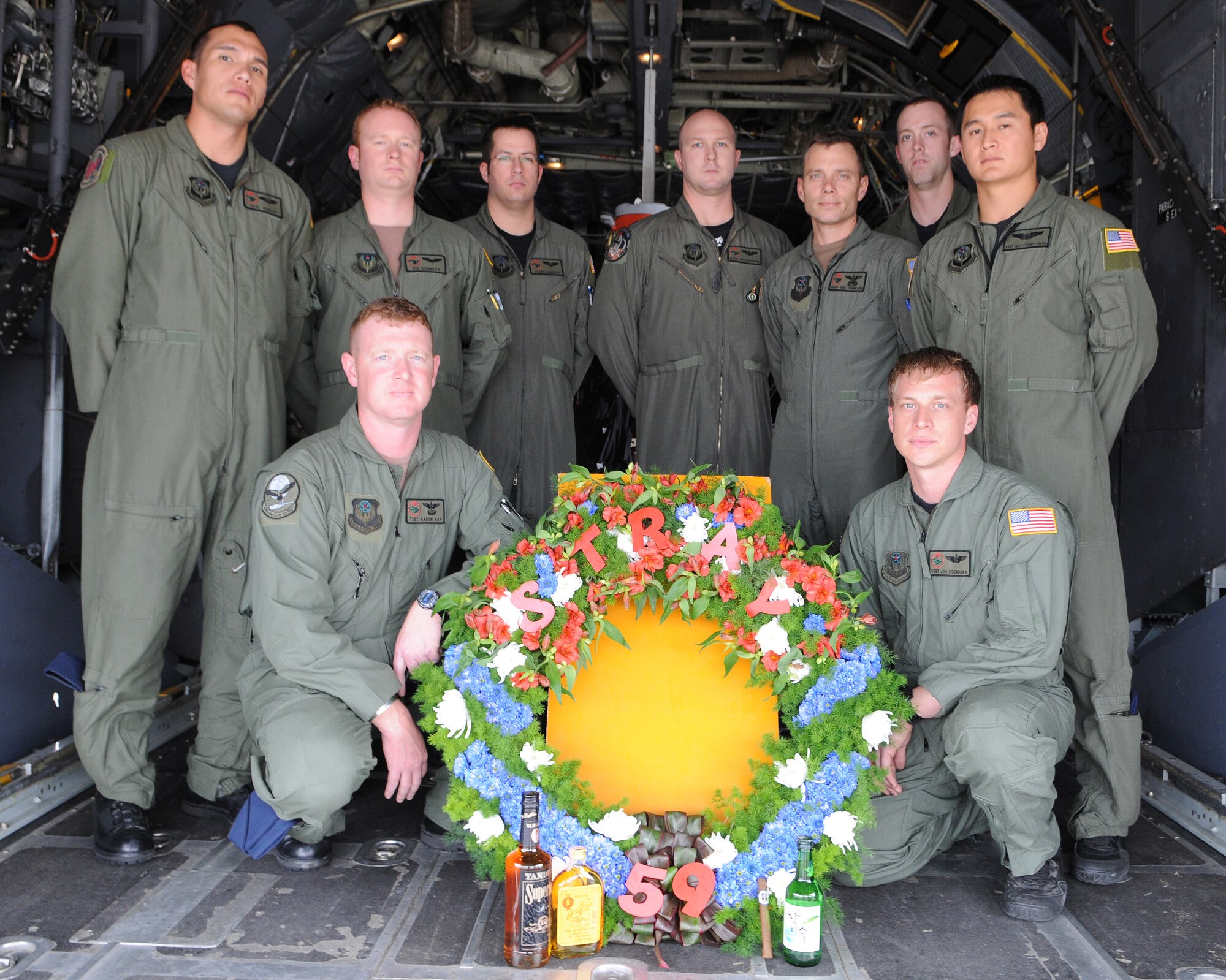 KADENA AIR BASE, Japan -- The crew of GOOSE 99 poses for a photo with the memorial wreath on the back of a 1st Special Operations Squadron MC-130H Combat Talon II here Feb. 26 before flying a memorial flight to honor fallen brethren that were lost 28 years ago when a 1st SOS MC-130E, call sign STRAY 59, crashed during an exercise killing eight crew members and 15 passengers. The crew of GOOSE 99 flew from here to reach the exact coordinates of the crash site to release the ceremonial wreath. The memorial flight has been flown every year since the tragic accident in 1981. The crew members of GOOSE 99 are (from left to right): Back row: Back row: Capt. Pedro Ovalle, Capt. Sid Kennedy, Capt. Jason Gossett, Capt. Buck Hodgkinson, Master Sgt. Erik Thompson. Tech Sgt. Matthew Micks, and Tech. Sgt. Dae Kyung Kwon. Front row: Tech. Sgt. Aaron Kay and Staff Sgt. Jim Kosnosky. (U.S. Air Force photo by Tech. Sgt. Aaron Cram) 