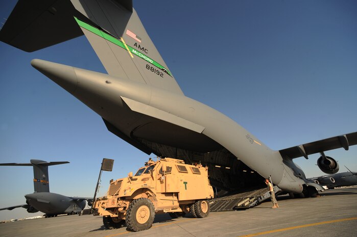Staff. Sgt. Thomas Daga, 8th Expediitionary Air Mobility Squadron load team member, watches for overhead clearance as a Mine Resistant Ambush Protective vehicle is backed into a C-17 Globemaster III for transport at a non-disclosed Southwest Asia location, Feb 12, 2010. (U.S. Air Force photo by Tech. Sgt. Michelle Larche)