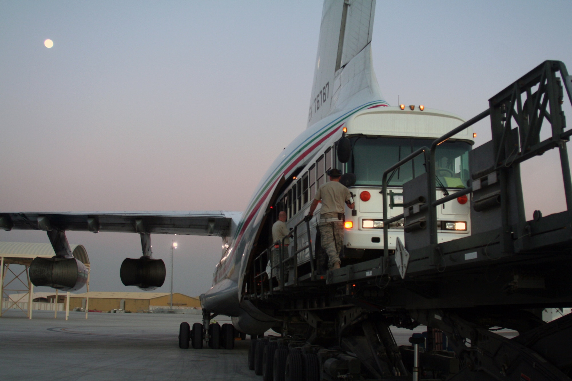 Air transportation Airmen assigned to the 380th Expeditionary Logistics Readiness Squadron Air Terminal Operations Center load a 44-passenger bus weighing more than 20,000 pounds onto a Russian-built IL-76 transport plane during operations at a non-disclosed base in Southwest Asia on Dec. 30, 2009. The bus was one of two that were loaded on the IL-76 for transport to Afghanistan. The 380th Air Expeditionary Wing supports Operations Iraqi Freedom and Enduring Freedom and the Combined Joint Task Force-Horn of Africa.  (U.S. Air Force Photo/Tech. Sgt. Scott T. Sturkol)