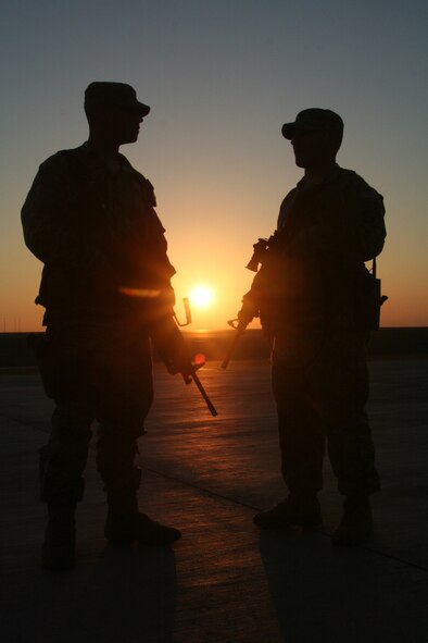 Airman 1st Class Johnny Hinojosa and Staff Sgt. Matthew James, both security forces journeyman assigned to the 380th Expeditionary Security Forces Squadron, watch over the flightline at a non-disclosed base in Southwest Asia on Dec. 30, 2009. The 380th ESFS and the 380th Air Expeditionary Wing support Operations Iraqi Freedom and Enduring Freedom and the Combined Joint Task Force-Horn of Africa. Airman Hinojosa is deployed from the 3rd Security Forces Squadron at Elmendorf Air Force Base, Alaska, and his hometown is San Diego, Calif. Sergeant James is deployed from the 81st SFS at Keesler Air Force Base, Miss., and his hometown is North Reading, Penn. (U.S. Air Force Photo/Tech. Sgt. Scott T. Sturkol)